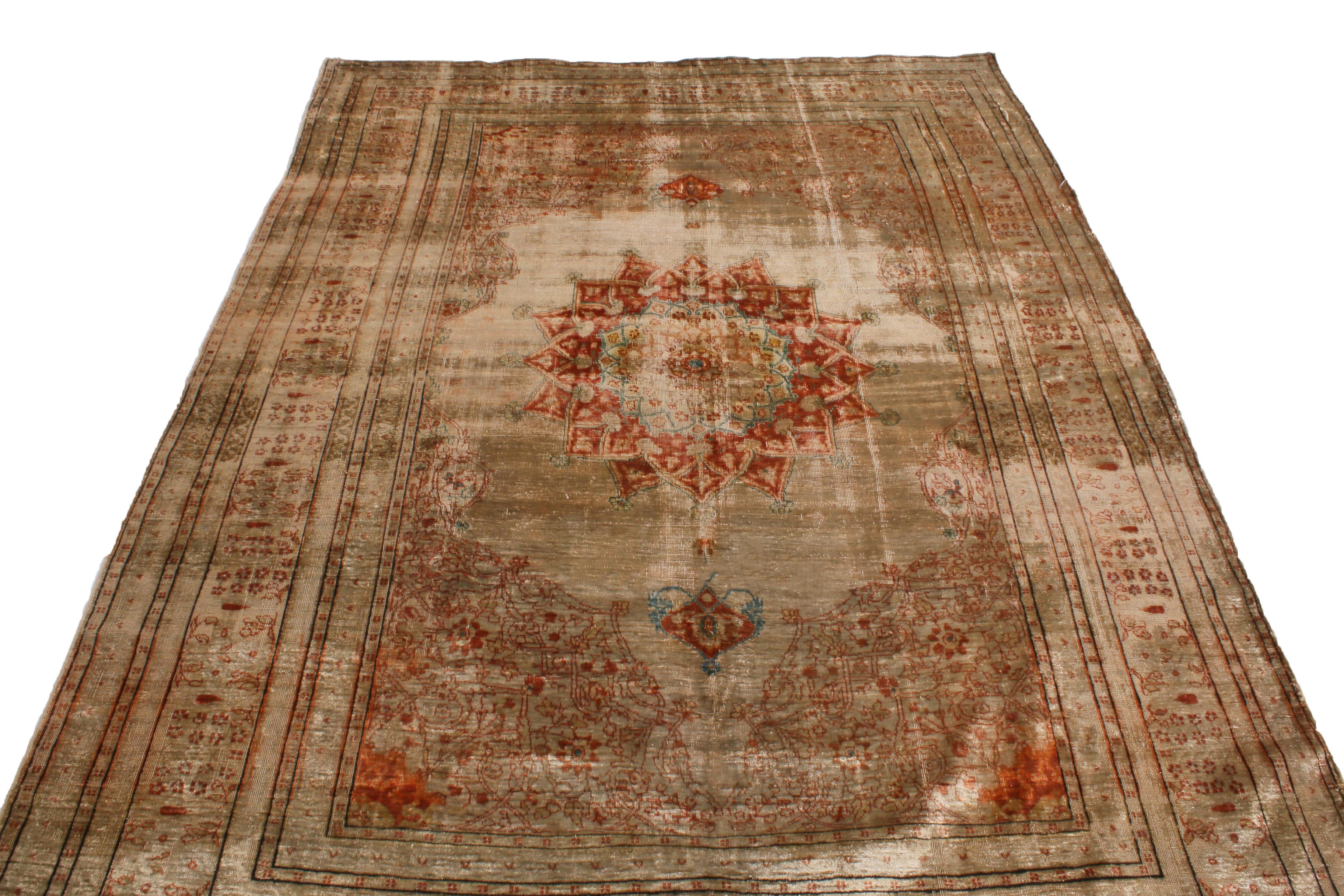 Originating from Persia in 1910, this antique Tabriz Persian rug is hand-knotted with a soft, quality wool pile married to some of the most distinguished muted and vibrant colorways. Featuring a medallion style field design in elevated brown and