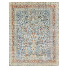 Ancien tapis de laine persane bleu de Tabriz en laine à motifs floraux, fait à la main