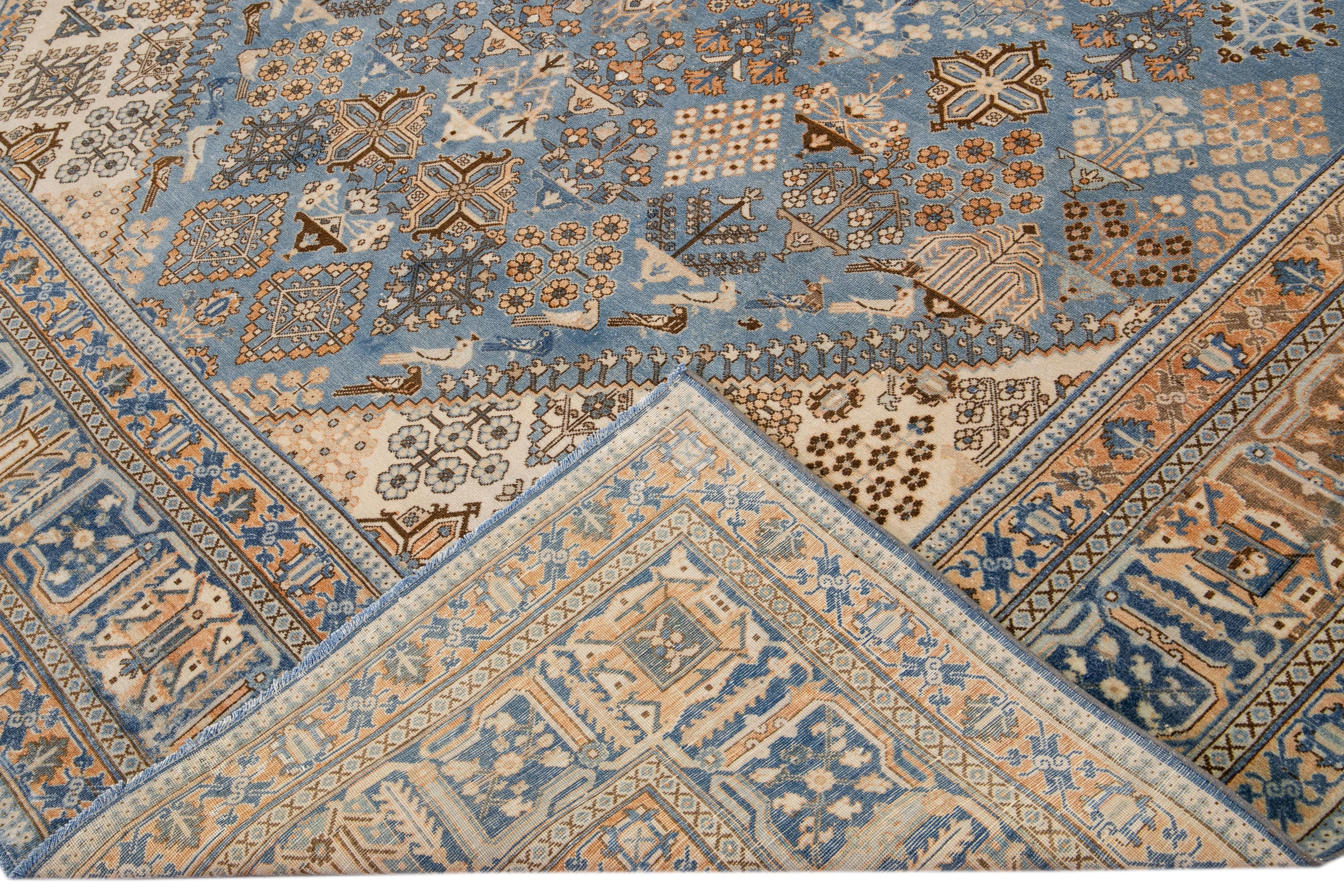 Beautiful antique Tabriz hand-knotted wool rug with the blue field. This Persian piece has a rusted designed frame and beige accents traditional in all-over geometric design. 

This rug measures: 8'9