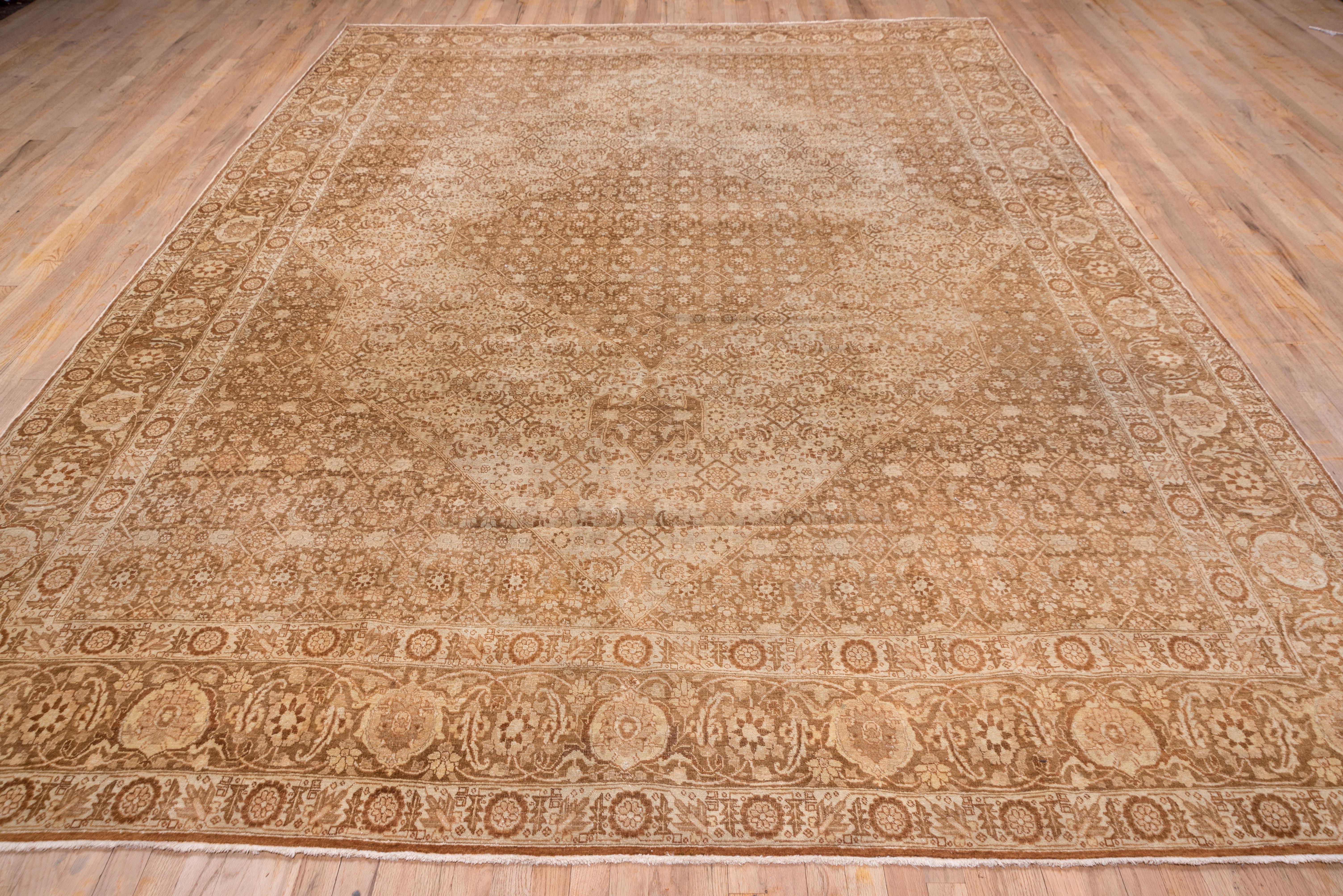 The rusty-brown layered 'book cover' field of this NW Persian town workshop carpet displays a dense, small figure Herati pattern within the Classic accompaniment of a turtle palmette and 'fish' leaf rust-brown main border and ivory Zanbaki pattern