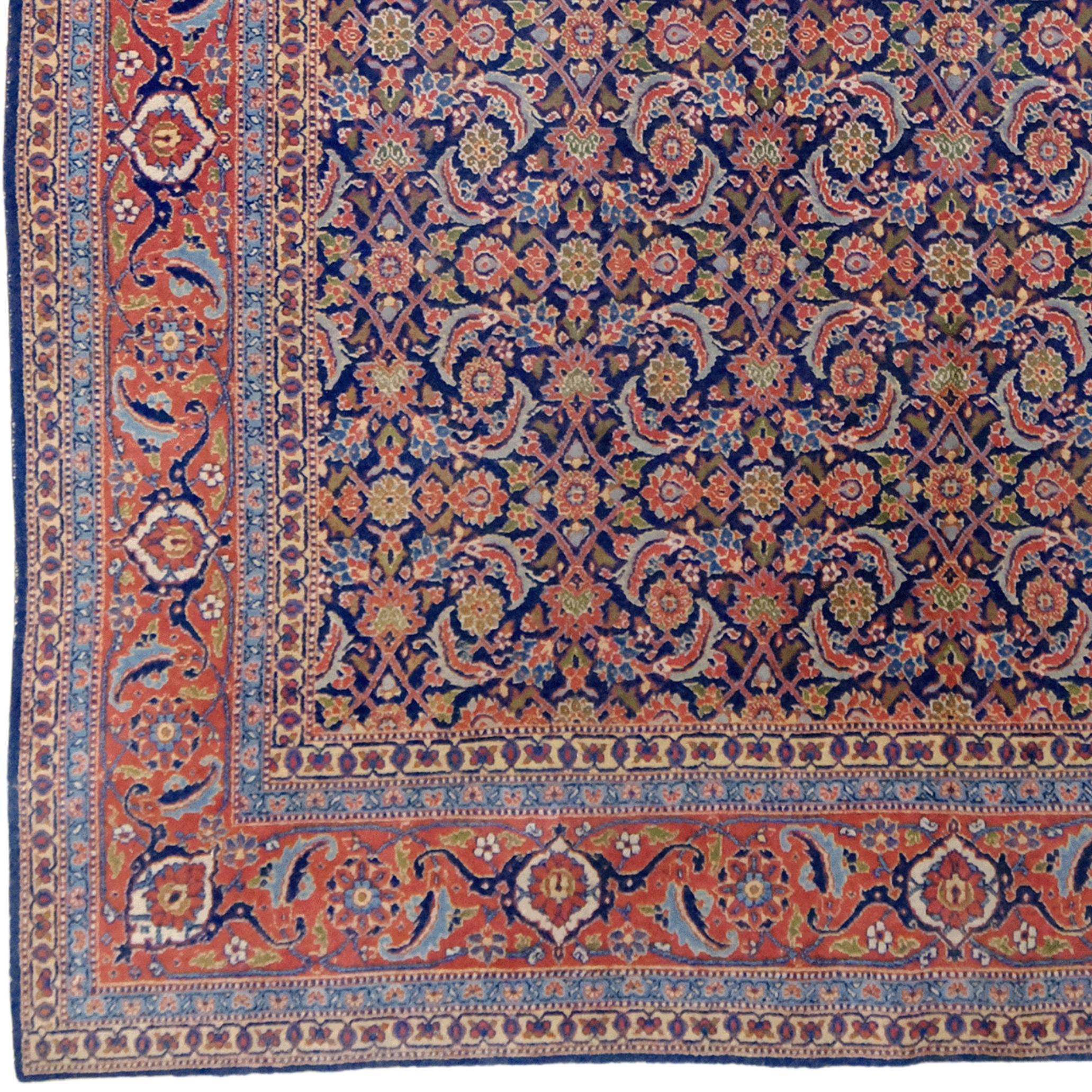 This magnificent Tabriz carpet comes from one of Iran's most renowned carpet centers. Woven in the early 20th century, this vintage carpet is a vibrant example of the magnificent carpet tradition of the East.

The carpet's rich blue and orange