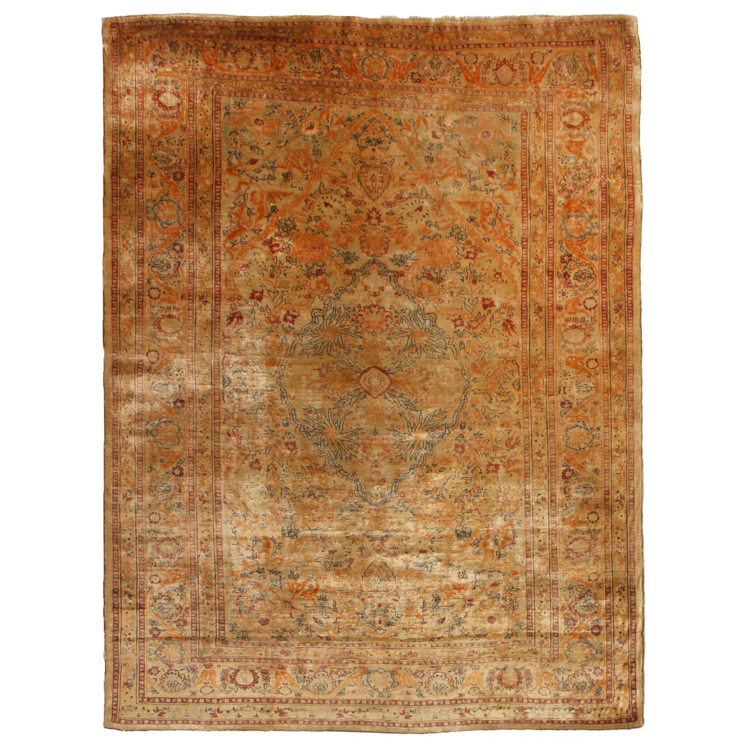 Hand knotted with a fine, naturally luminous silk originating from Persia in 1890, this though there are some minor allusions to lotus patterns, this antique Tabriz Persian rug enjoys a unique beauty in its golden brown colorway background in both