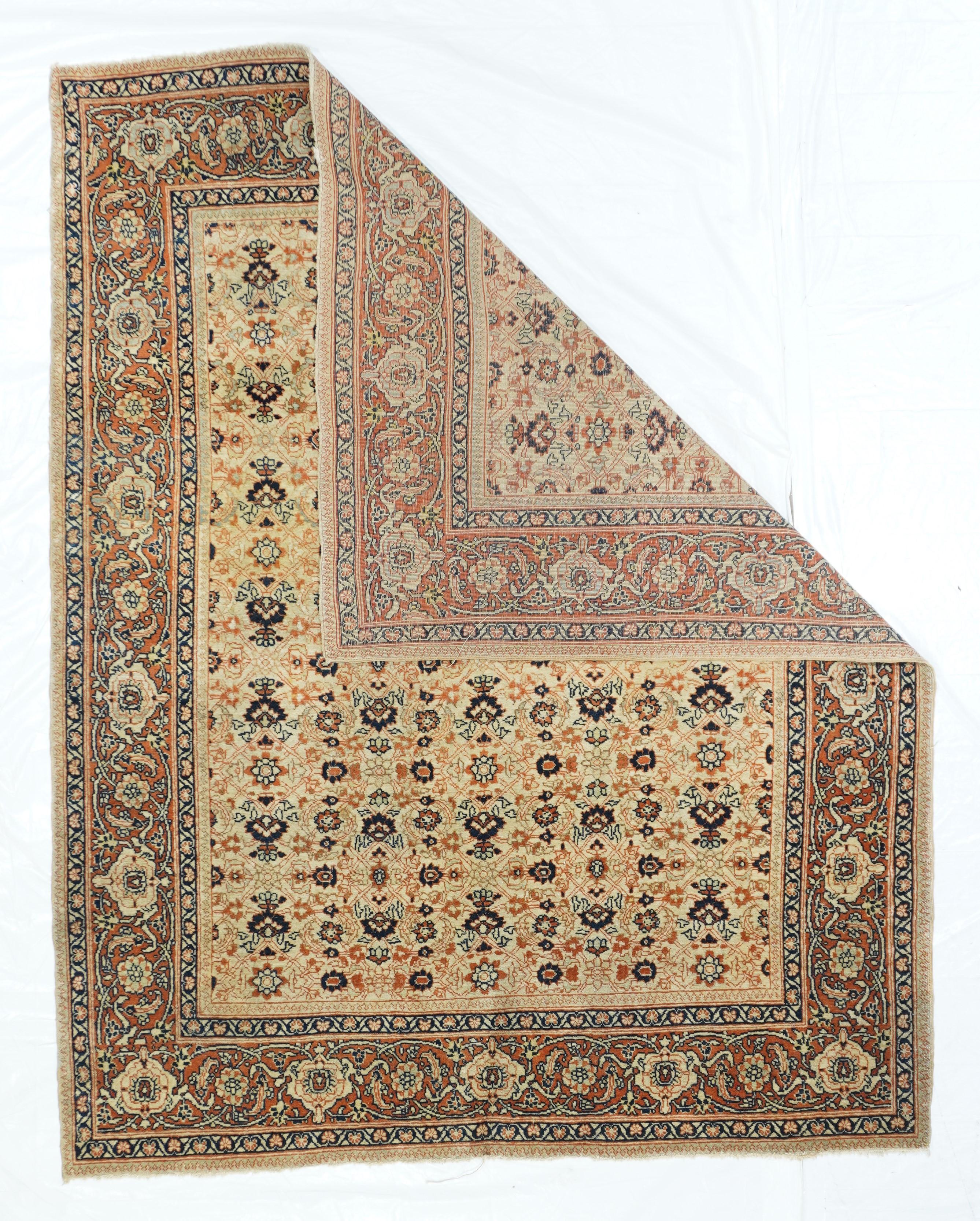 From the desirable “Hajji Jalili” period, roughly from 1885 to 1910, this well-woven, NW Persian urban scatter shows a creamy Sand field with an allover Herati rosette, open diamond, lancet leaf and palmette design, neatly framed  by a coral main