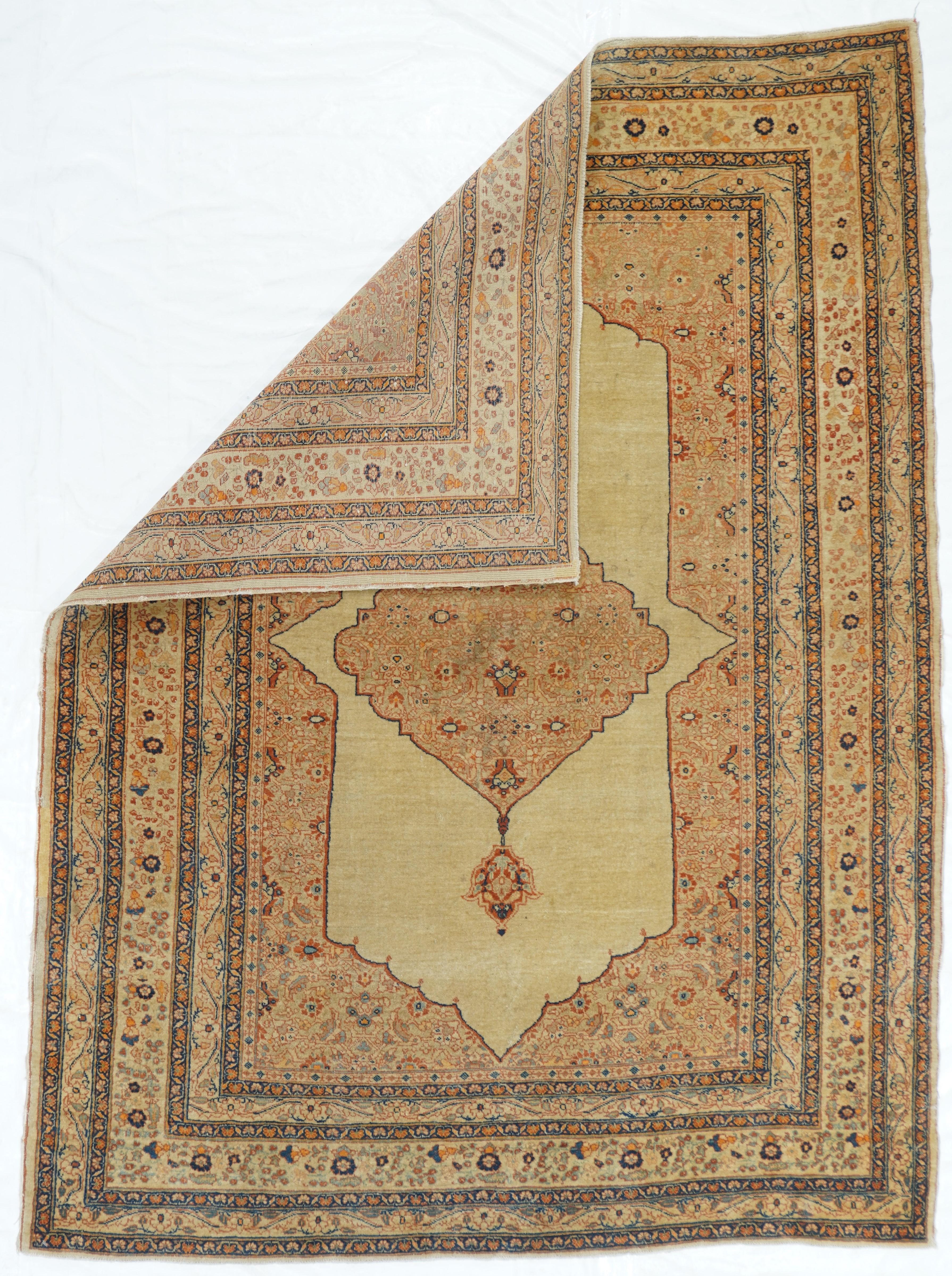 Antique Tabriz Haji Jalili Rug 4'2'' x 7'. The open sandy-cream subfield is set within Herati spandrels and supports a matching slightly shaped diamond medallion with small pendants. Numerous borders with a relatively narrow cream main stripe with a