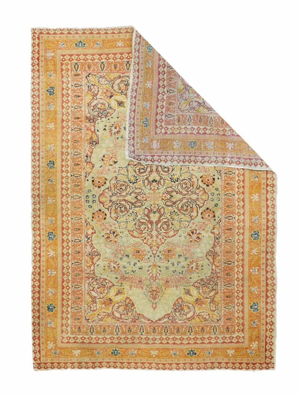 This antique scatter from an esteemed NW Persian city shows a straw field centred by a coral-rust volute medallion. Fan palmette vinery runs conformably along the medallion’s sides. Coral –rust corners. Cypress-pattern inner frame and goldenrod main