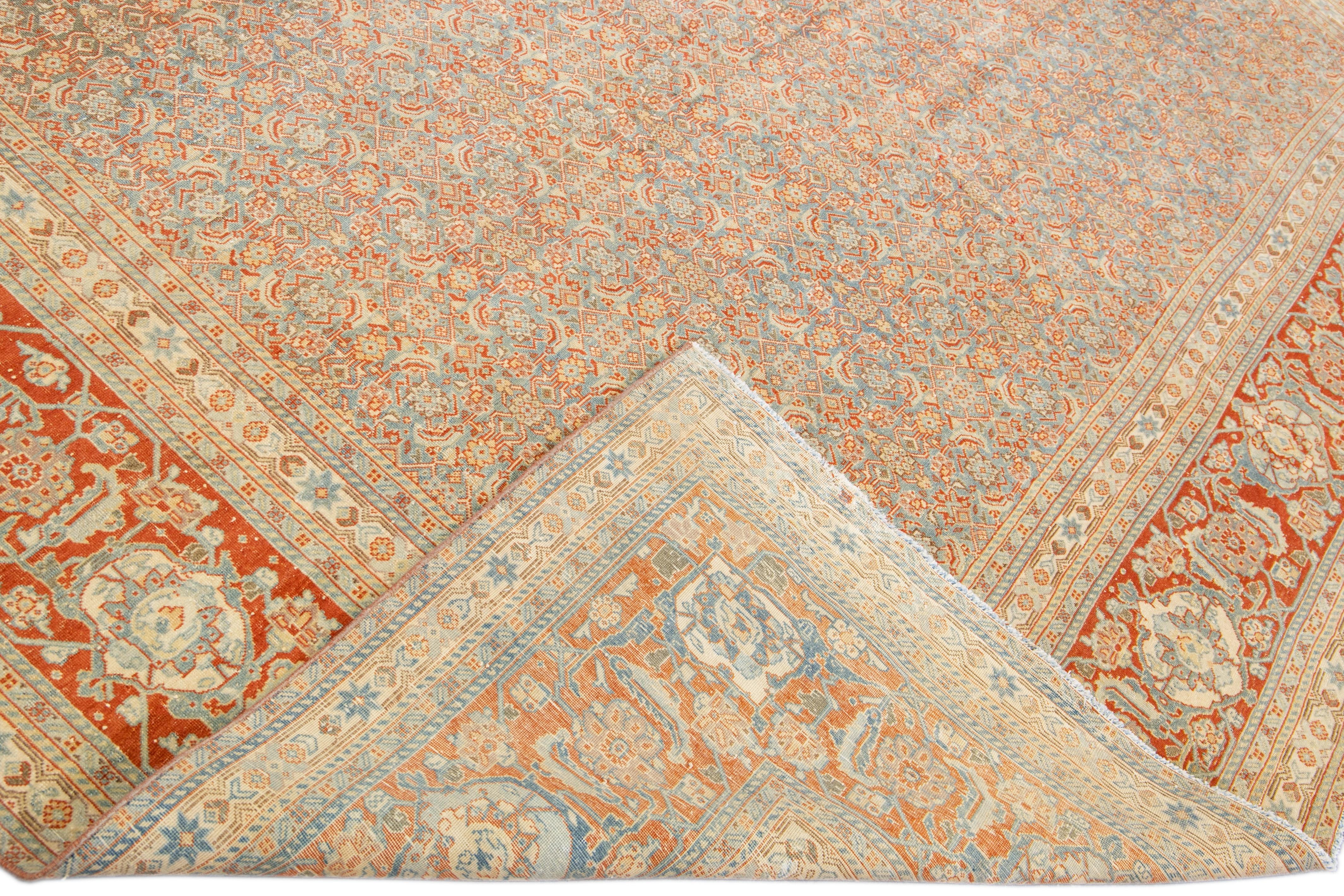 Beautiful antique Tabriz hand-knotted wool rug with the blue field. This Persian piece has a rusted designed frame and accents traditional in all-over geometric floral pattern design. 

This rug measures: 10' x 13'1