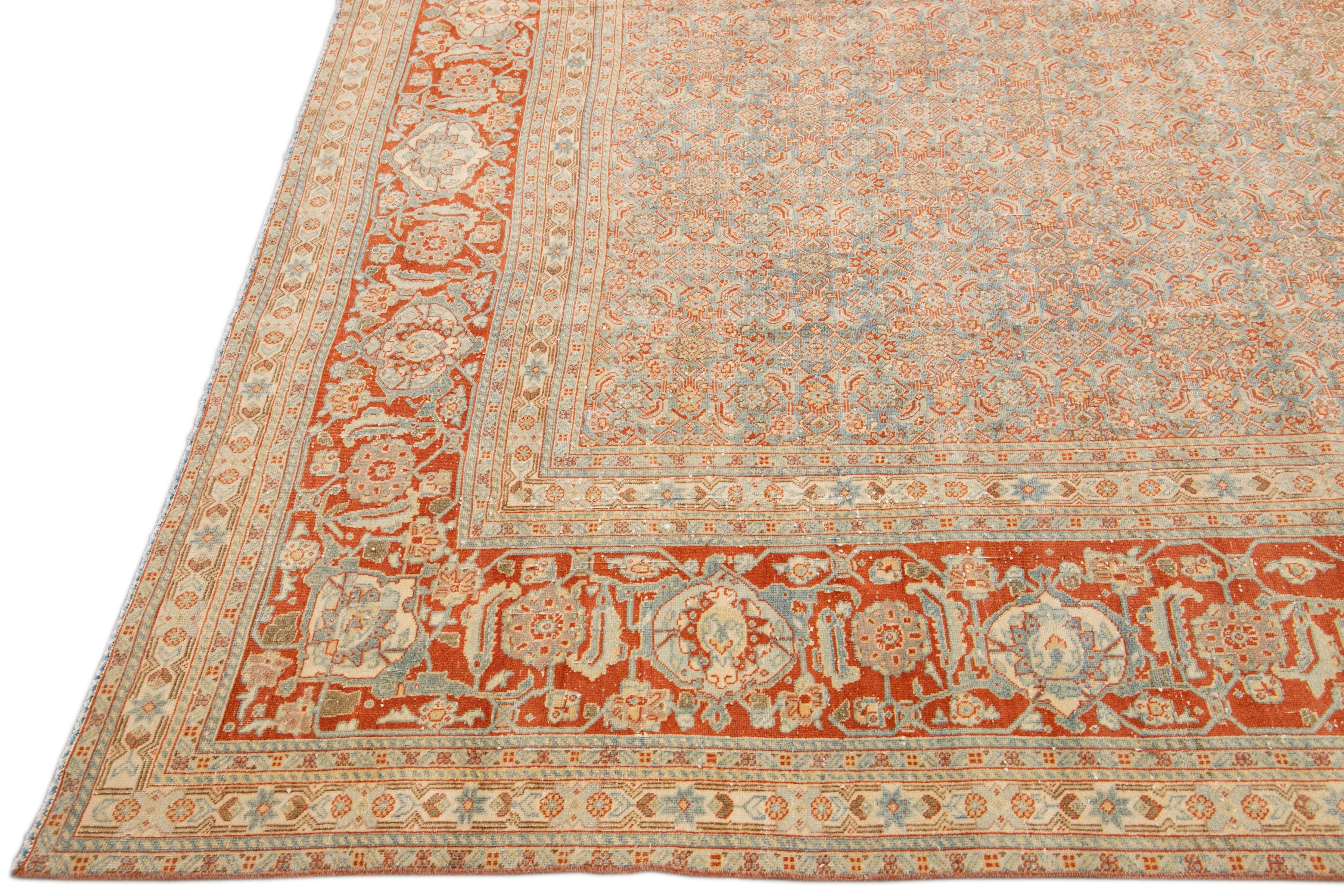 Early 20th Century Antique Tabriz Handmade Allover Designed Blue and Rust Persian Wool Rug For Sale