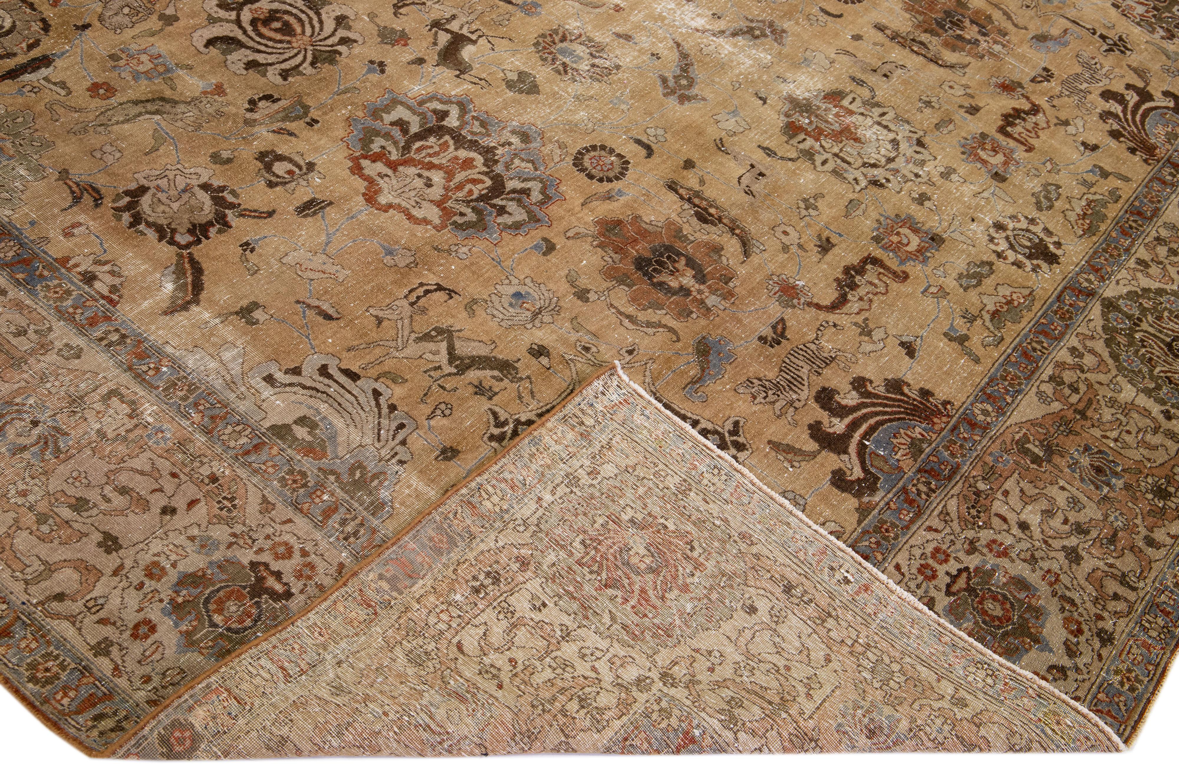 Beautiful antique Tabriz hand-knotted wool rug with a brown color field. This Persian rug has blue, green, and rust accents in a gorgeous all-over floral design.

This rug measures: 11'5