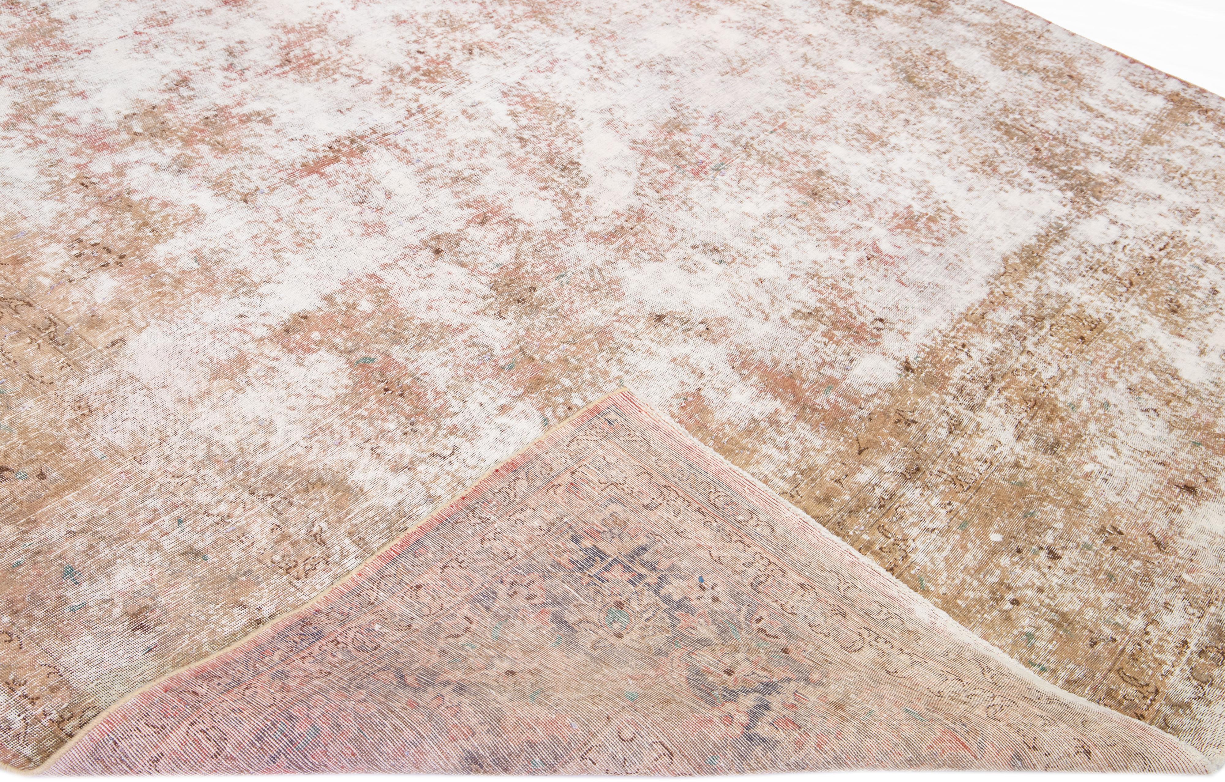 Beautiful Antique hand-knotted Tabriz oversize wool rug. This rug has a rust field with off-white accents all over the distressed design.

This rug measures 9' 4' x 19' 4