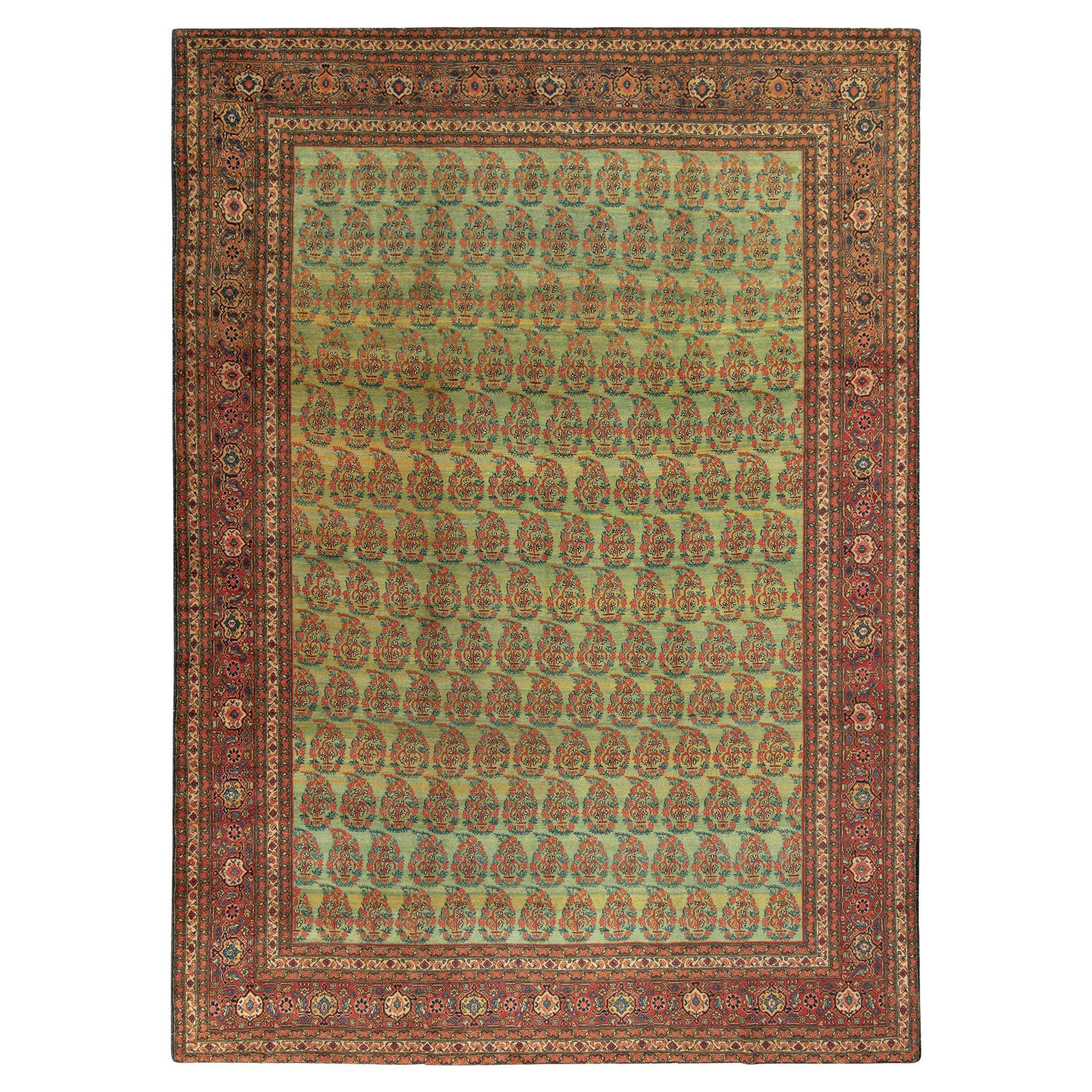 Antique Tabriz Persian Rug in an All over Green, Red Floral Pattern For Sale