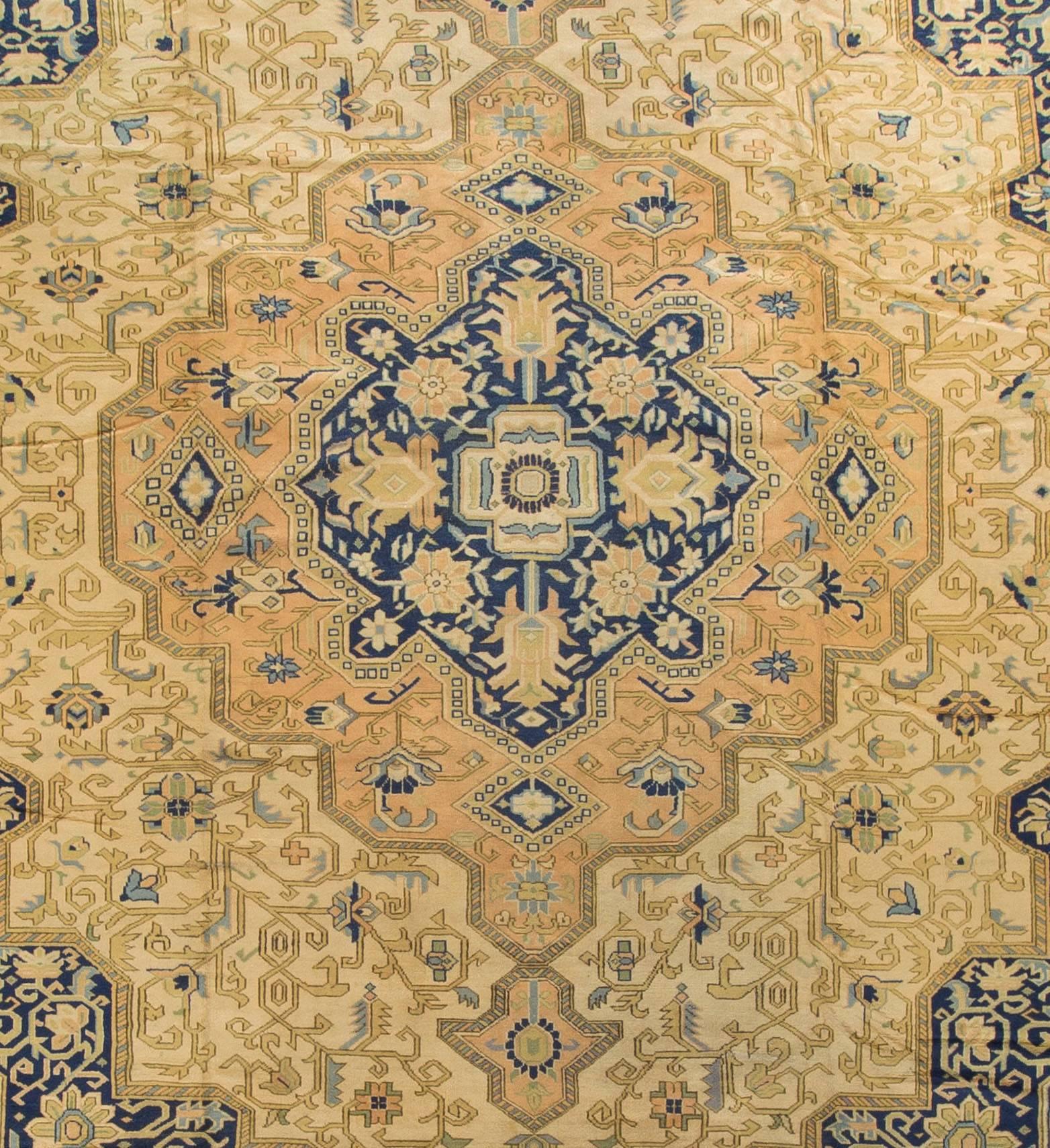A lovely antique Tabriz circa 1900 rug with the design so typical of this area. The three layered medallion has an arabesque edging and is filled with various palmettes, curved leaves and scrolling, wiry vines. This activity is continued in the