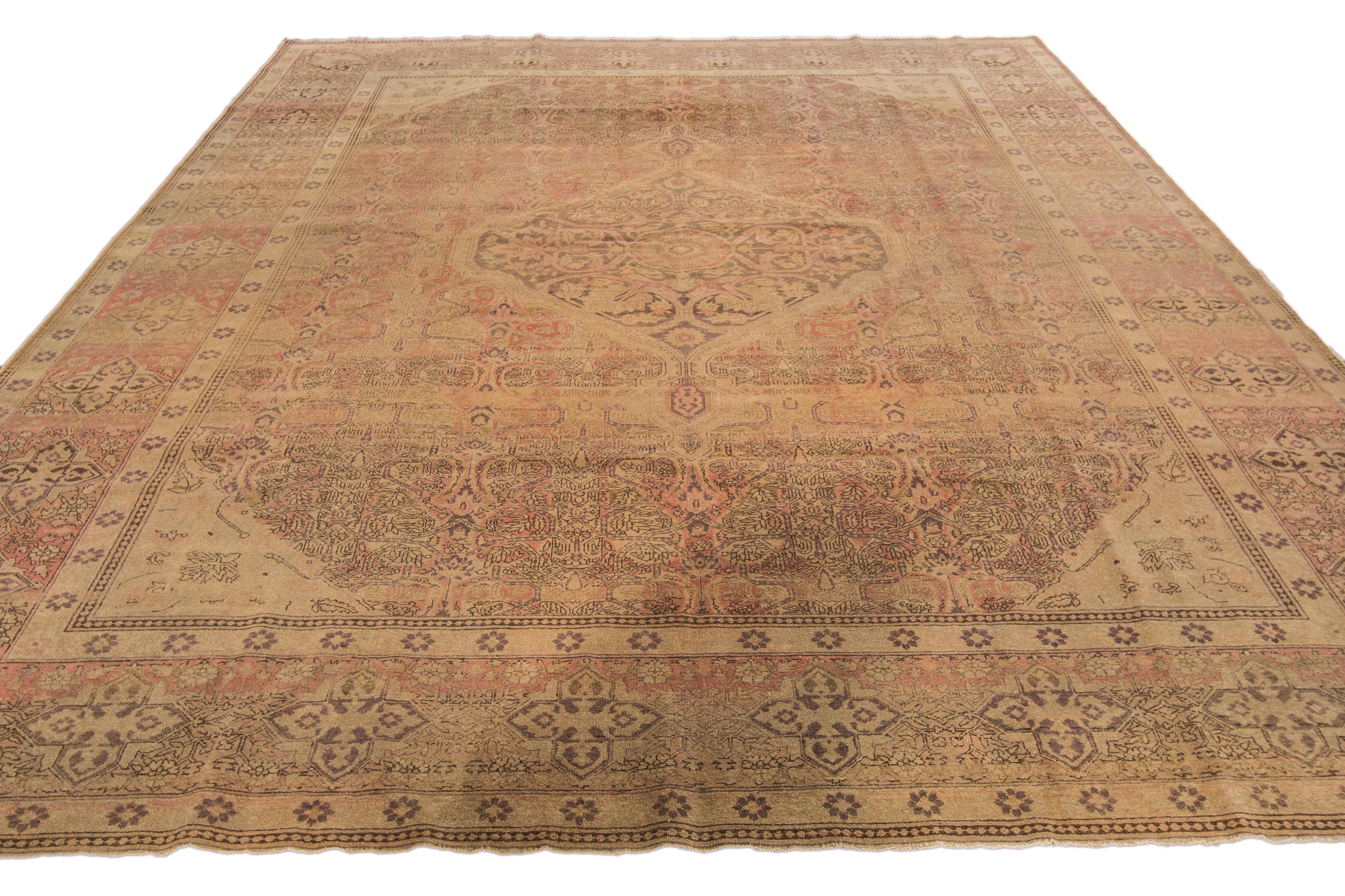 Beautiful antique Tabriz hand-knotted wool rug with the tan field. This Persian piece has a rusted designed frame and accents traditional in all-over medallion floral design.

This rug measures: 9'1