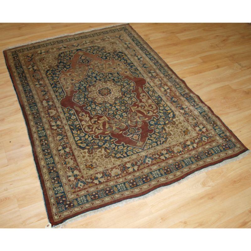 Antique Tabriz rug of classic design with a central medallion surrounded with floral sprays.

The rug has a change of colour(abrash) to the field which adds to the attraction of the rug. The soft blues and ivory colour give the rug a light