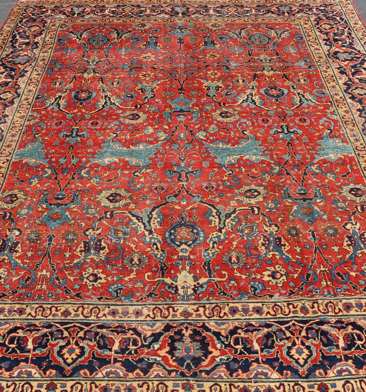 Persian Antique Tabriz Rug with All Over Design in Rust Red, Blue's, Yellow, and L. Blue For Sale