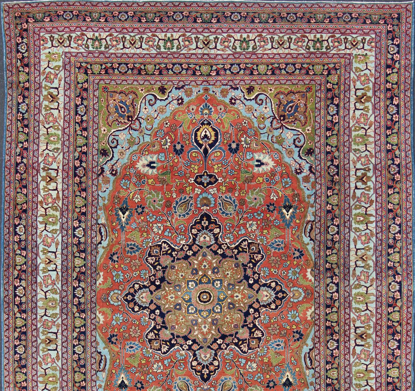 Finely woven antique Tabriz rug with circular, script-style medallion and orange field, Keivan Woven Arts/ rug / 17-0304. Classic Persian rug, traditional Persian rug, traditional Tabriz.
Measures: 10'1 x 14'2
This spectacular and colorful Persian