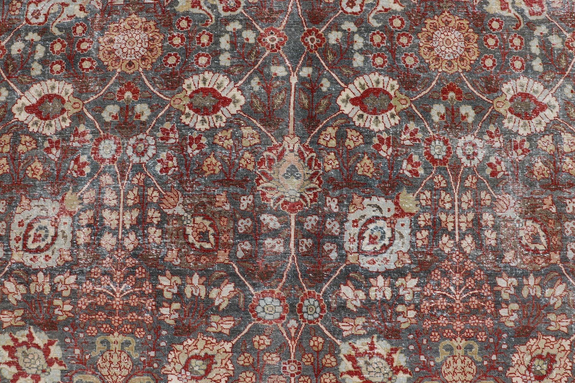 Persian Antique Tabriz with All-Over Floral Sub-Geometric Design In Charcoal and Red For Sale