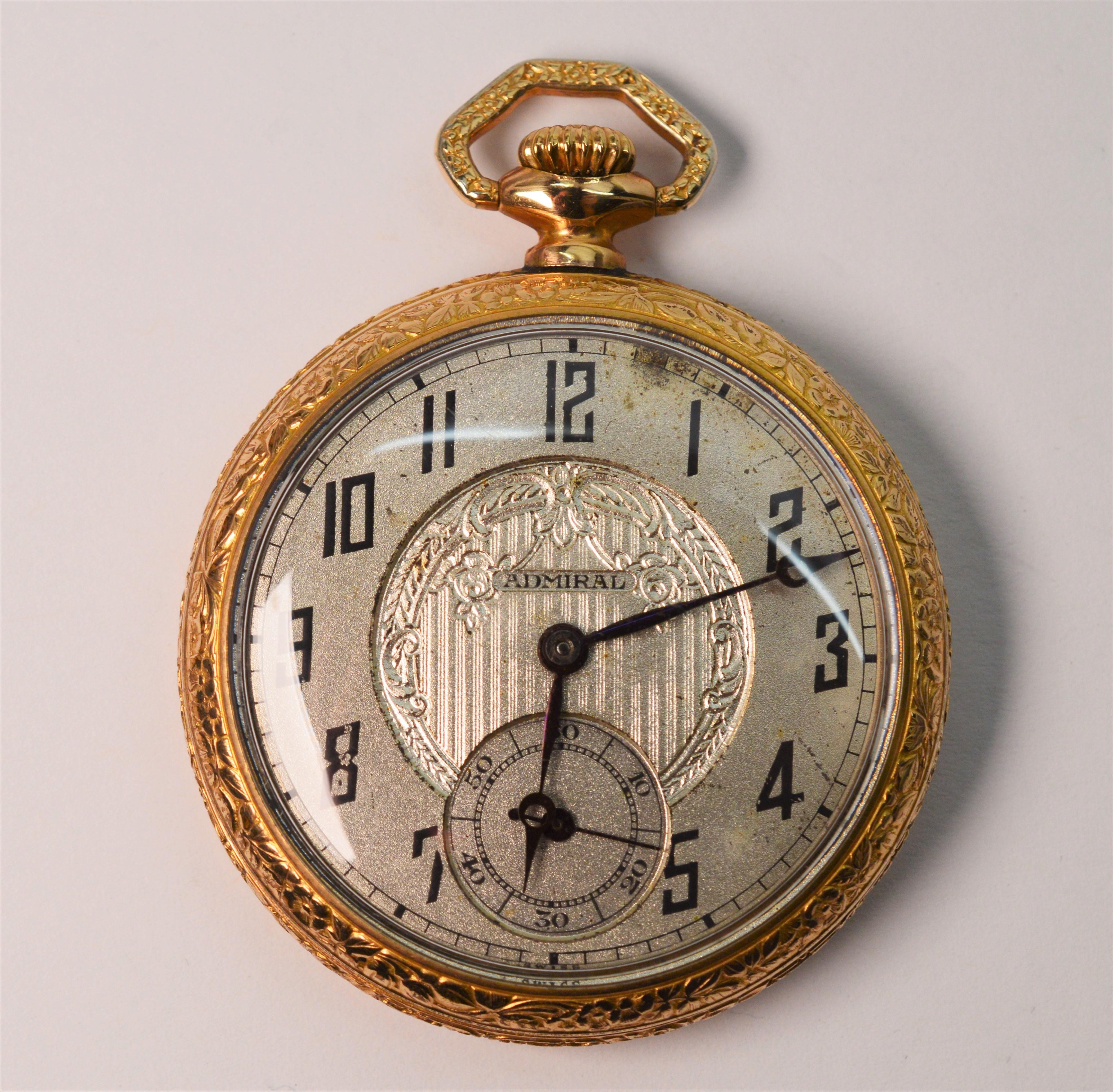 Enjoy the view into the inner workings of this circa 1920 antique gold filled Tacy Watch Company Admiral pocket watch with skeleton display back. In watch size 45mm (measuring 1-3/4 inches), this admiral has a silver toned face with fancy decorative
