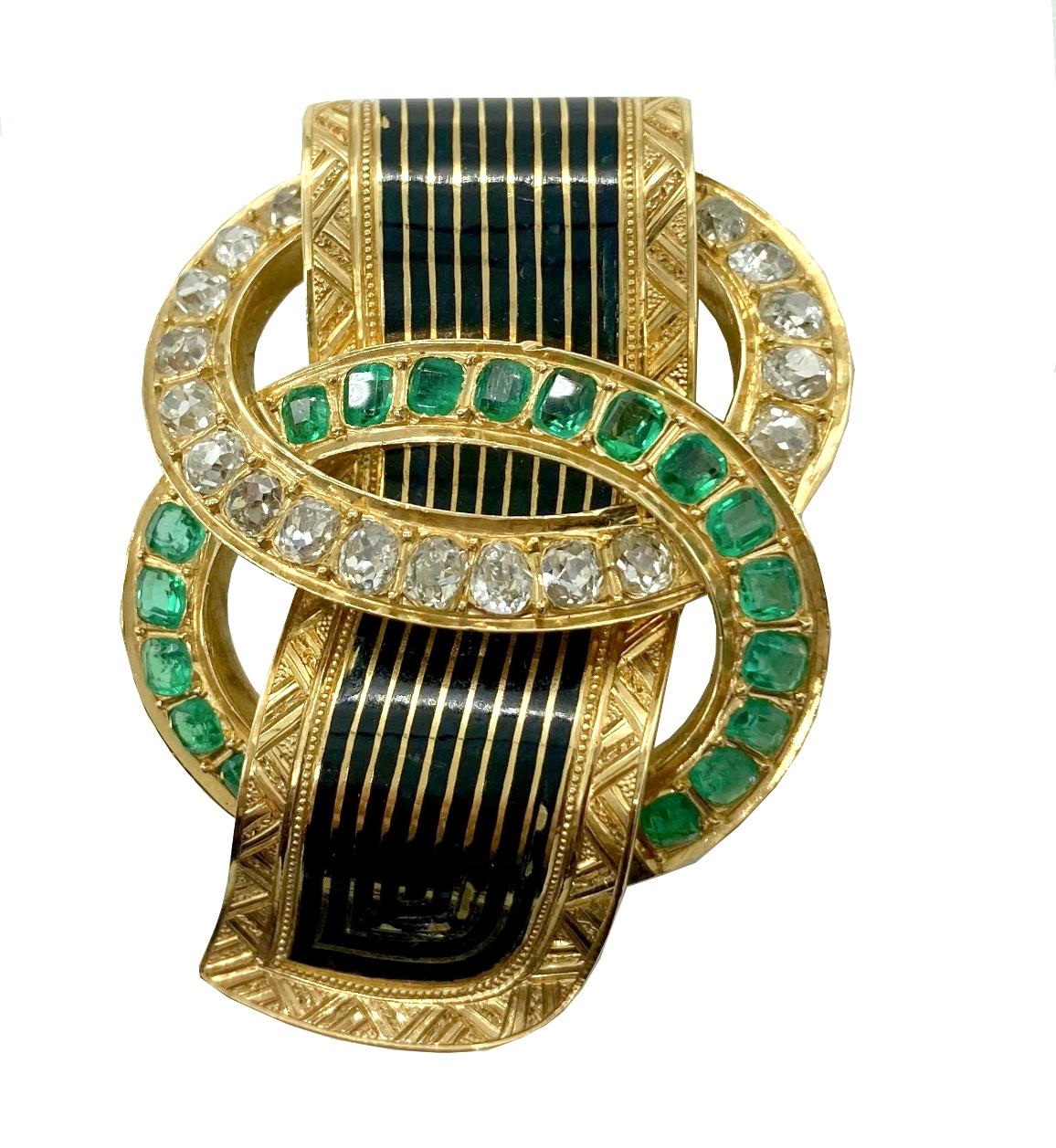 A superb taille d’epargne enamel, emerald, and diamond buckle brooch-pendant dating from nineteenth century France. Matching earrings and bracelet also available.