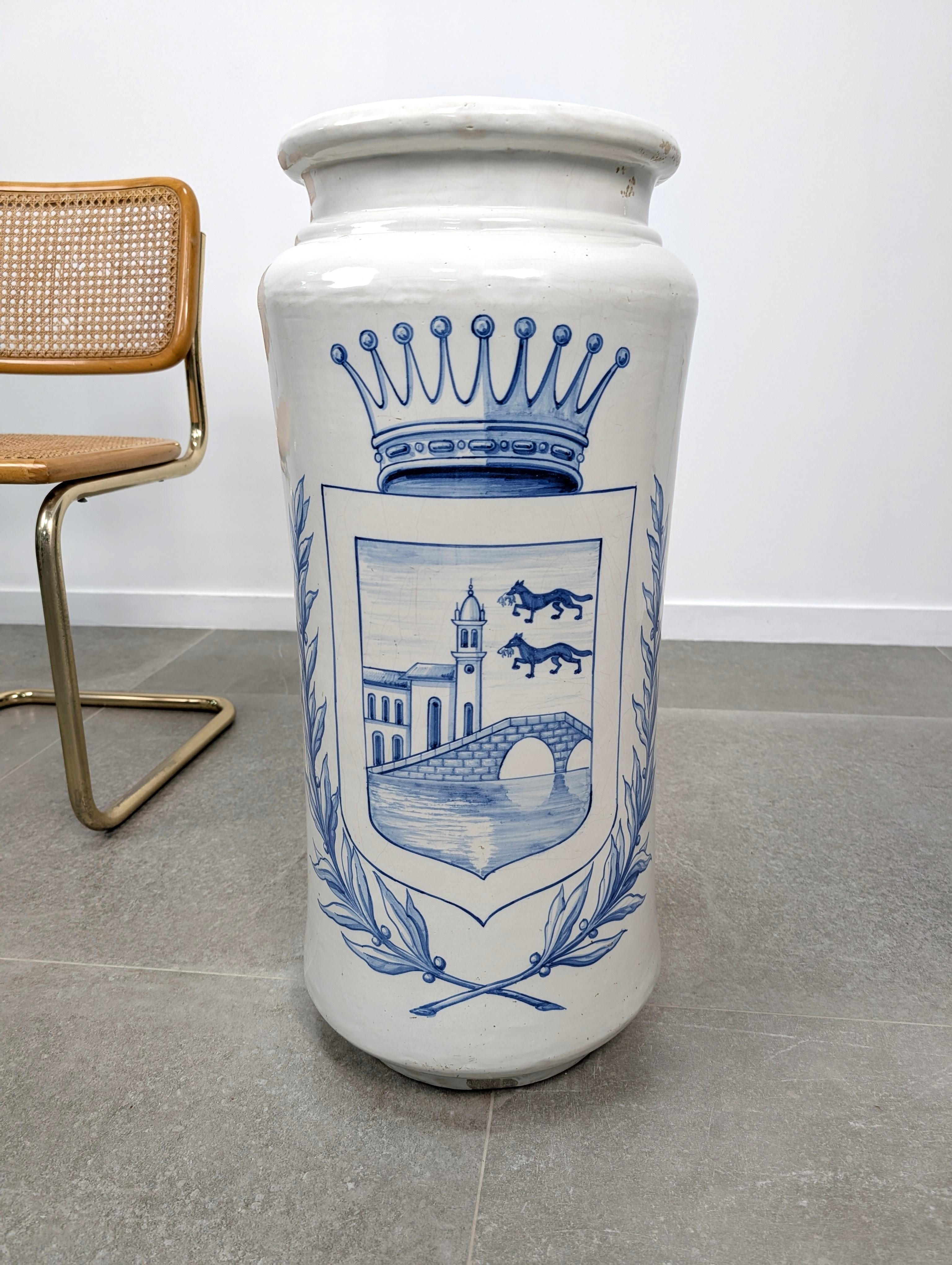 Large white Talavera ceramic umbrella and walking stick stand, featuring a hand-painted Bilbao coat. The piece is stamped at the base.
