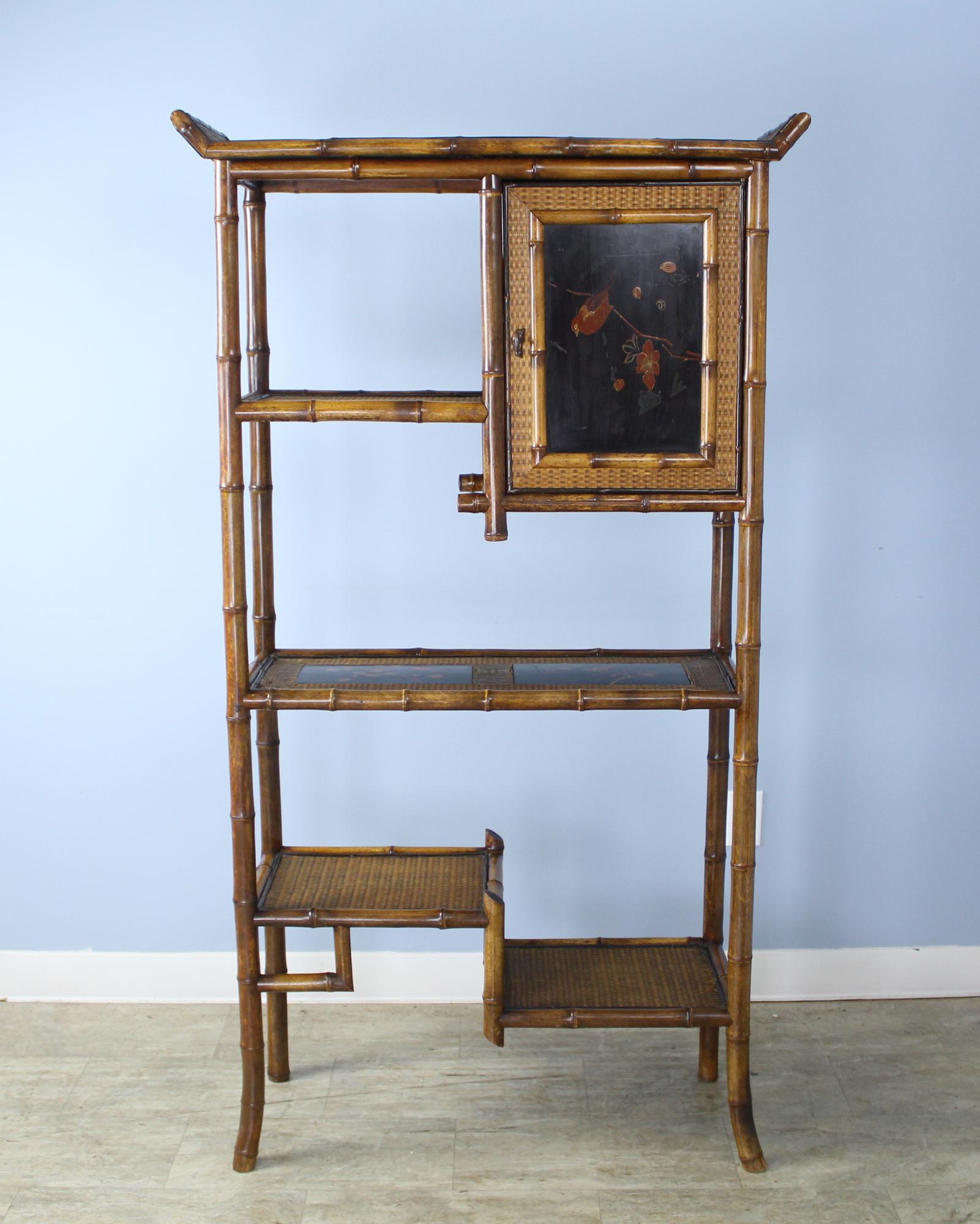 A highly decorative and unusual bamboo bookcase with a small cupboard. We love the black lacquered chinoiserie deign on the center shelf, and the subtle pattern woven into the rush on the sides.