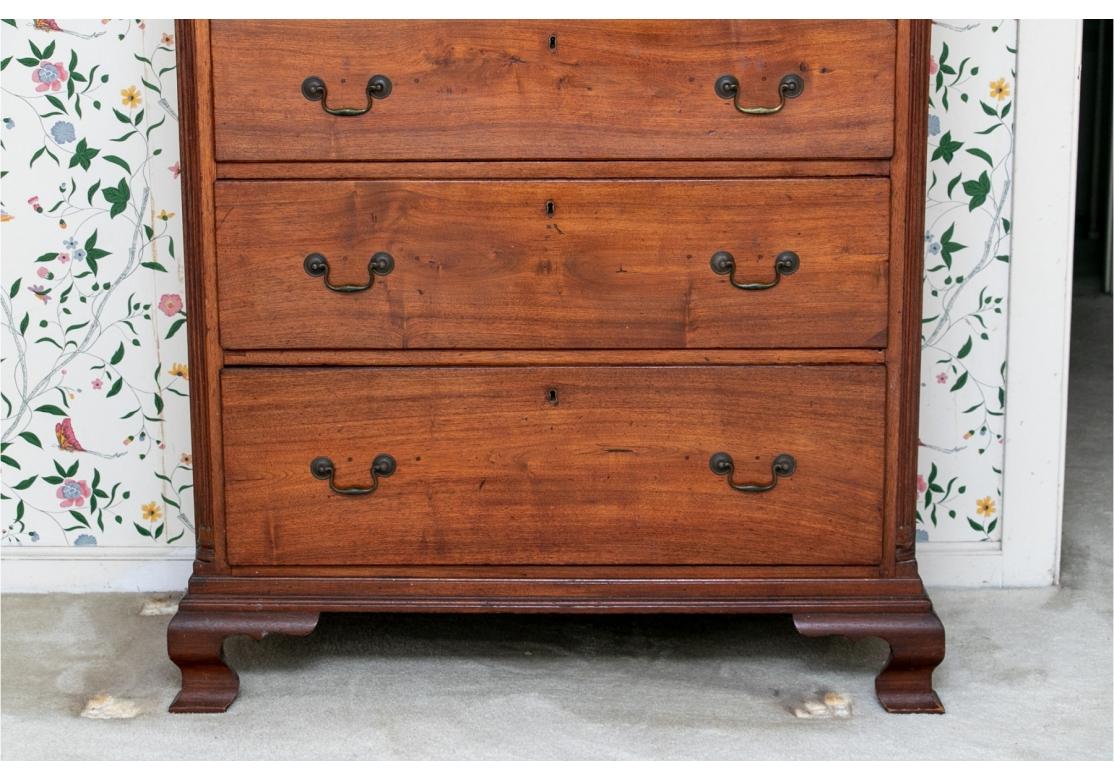 A handsome Antique Chest with fine traditional form and good color. Antique tall chest of drawers with three over two over four graduated drawers. The crown moulding with fluted band, the drawers flanked by fluted columns and the whole resting on