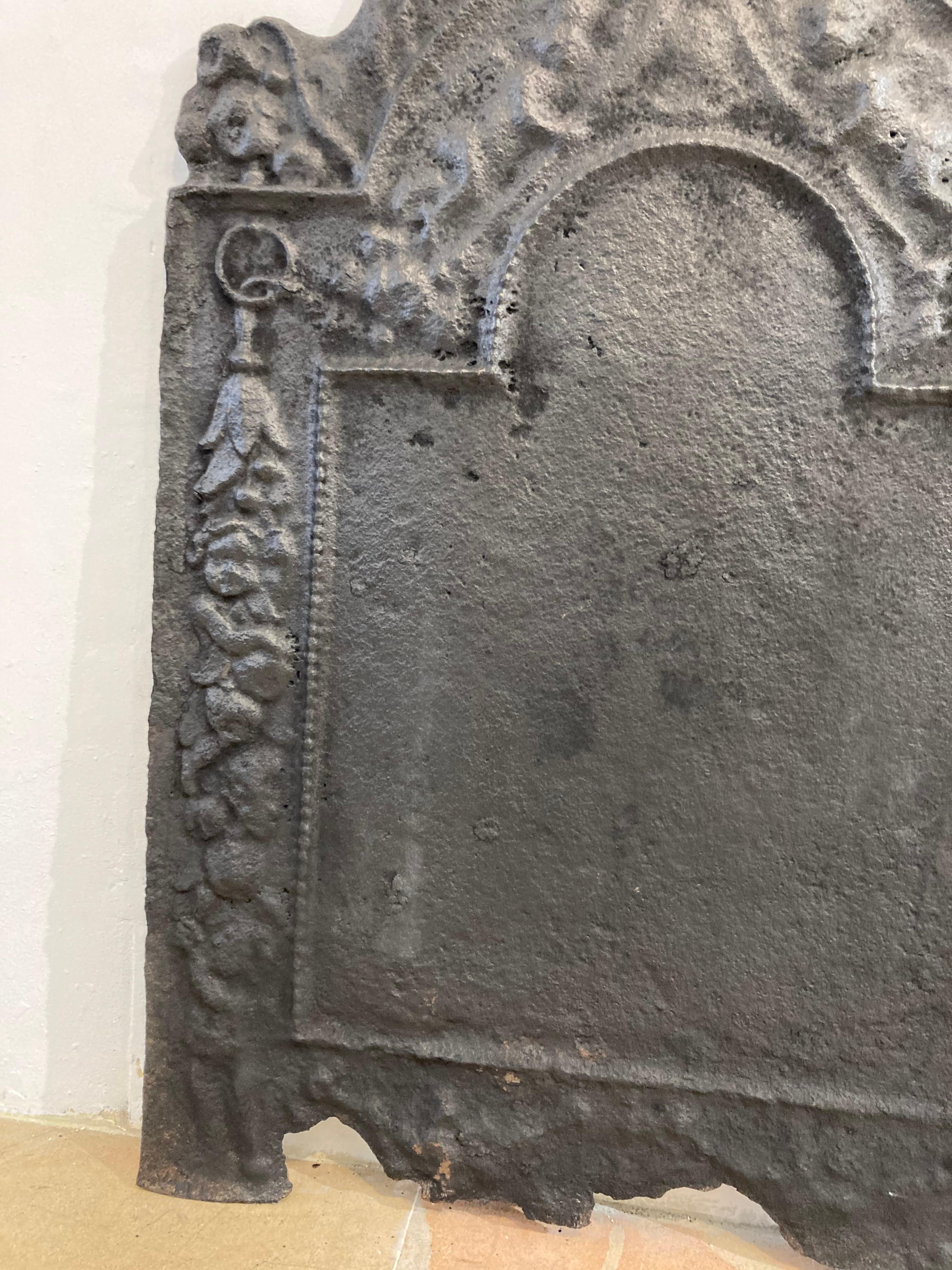 Lovely decorative cast iron fireback or backsplash.
Has been used well during its live and this shows.
A lot of details have slowly faded and the bottom is missing some pieces.

Would be a great conversation piece, perfect size.
 