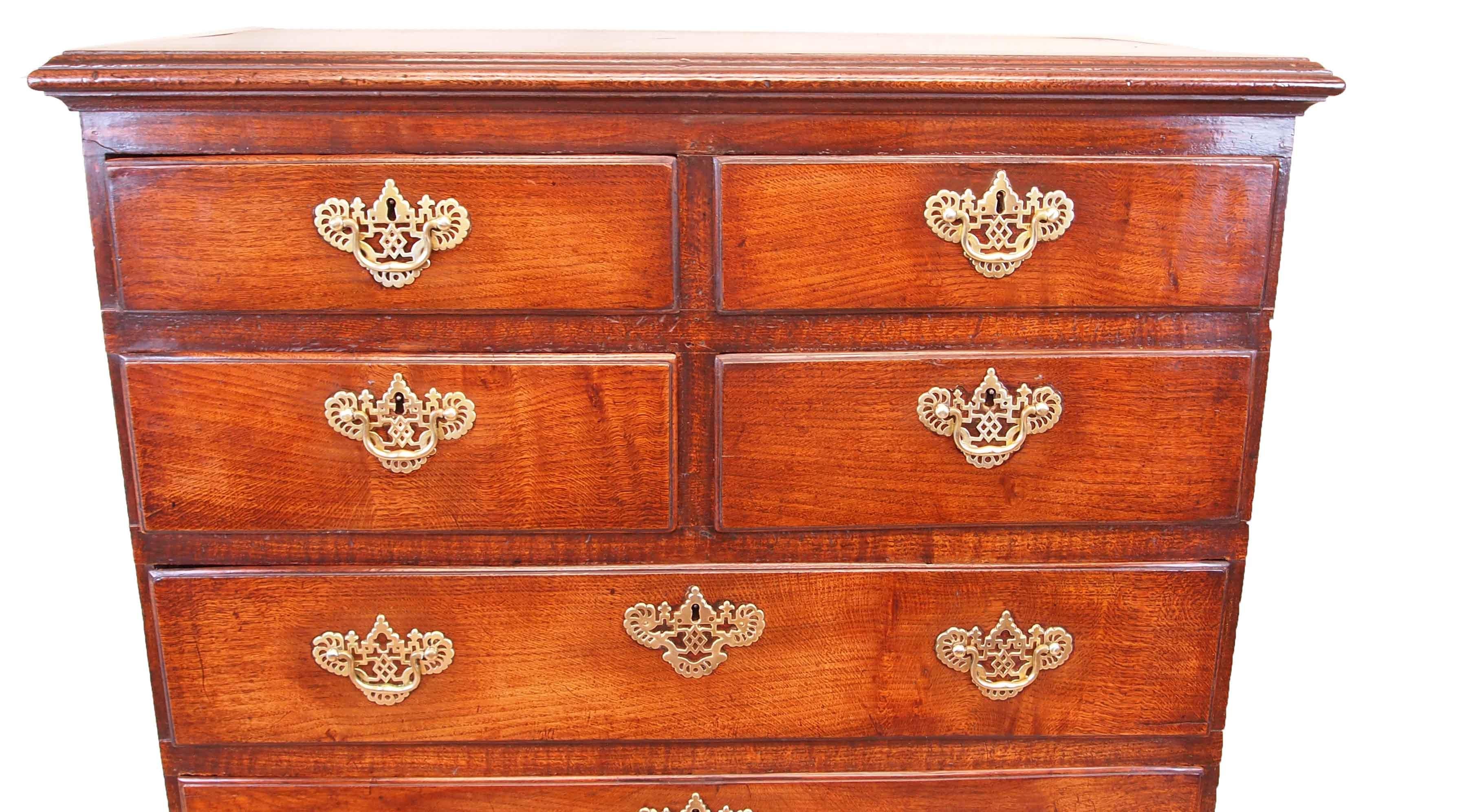 A delightful mid-18th century Georgian tall oak chest
of four short and four long drawers retaining exceptional
rich color and patina throughout and original brasswear
raised on original shaped bracket feet

(This is one of the most simple, but