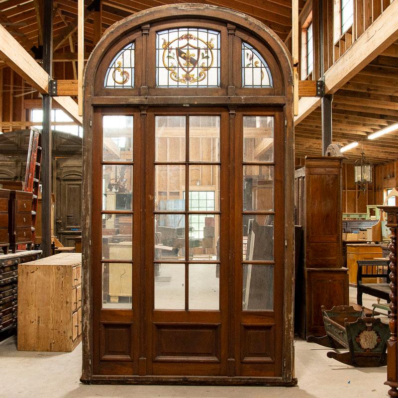 There is a refined elegance about this enchanting set of salvaged arched glass doors from France. At 10' tall, they are statuesque and create a grand impression. All 3 sections are hinged and able to open, while the sides can be secured/locked if