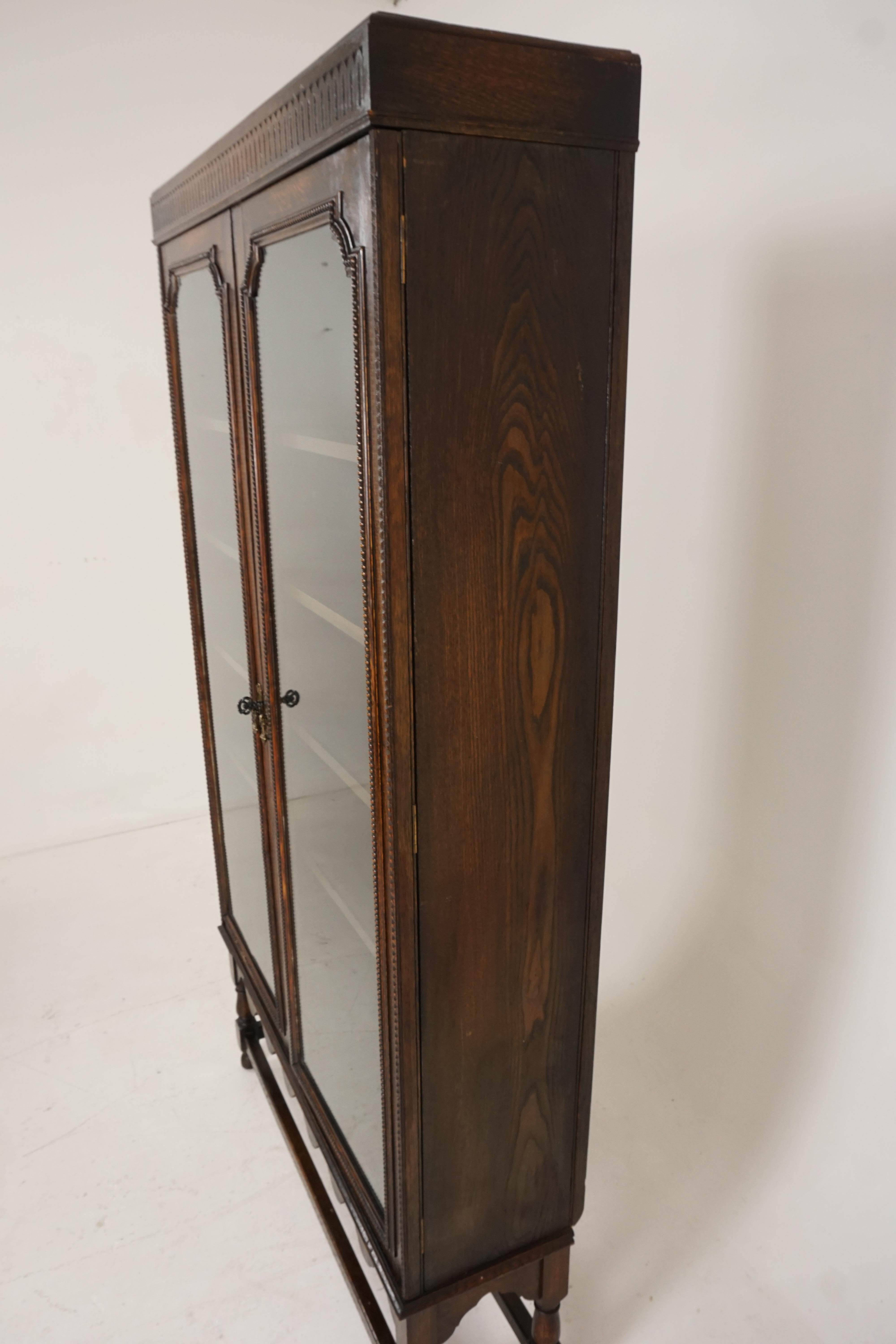 tall antique cabinet with glass doors