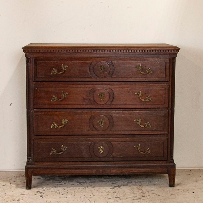 The deep patina seen in this stately oak chest of drawers is all original, as it was made in the late 1700s. The turned columns, dentil molding, and paneled drawers all add to the handsome lines of this tall chest. Originally made in 3 sections, the