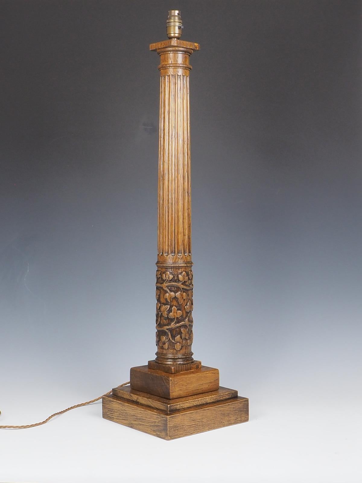 Die antike korinthische Tischlampe aus Eichenholz ist ein atemberaubendes Stück, das Eleganz und Raffinesse ausstrahlt. Diese mit viel Liebe zum Detail gefertigte Lampe zeichnet sich durch ihr kunstvoll geschnitztes Blattwerk am Sockel aus. Der