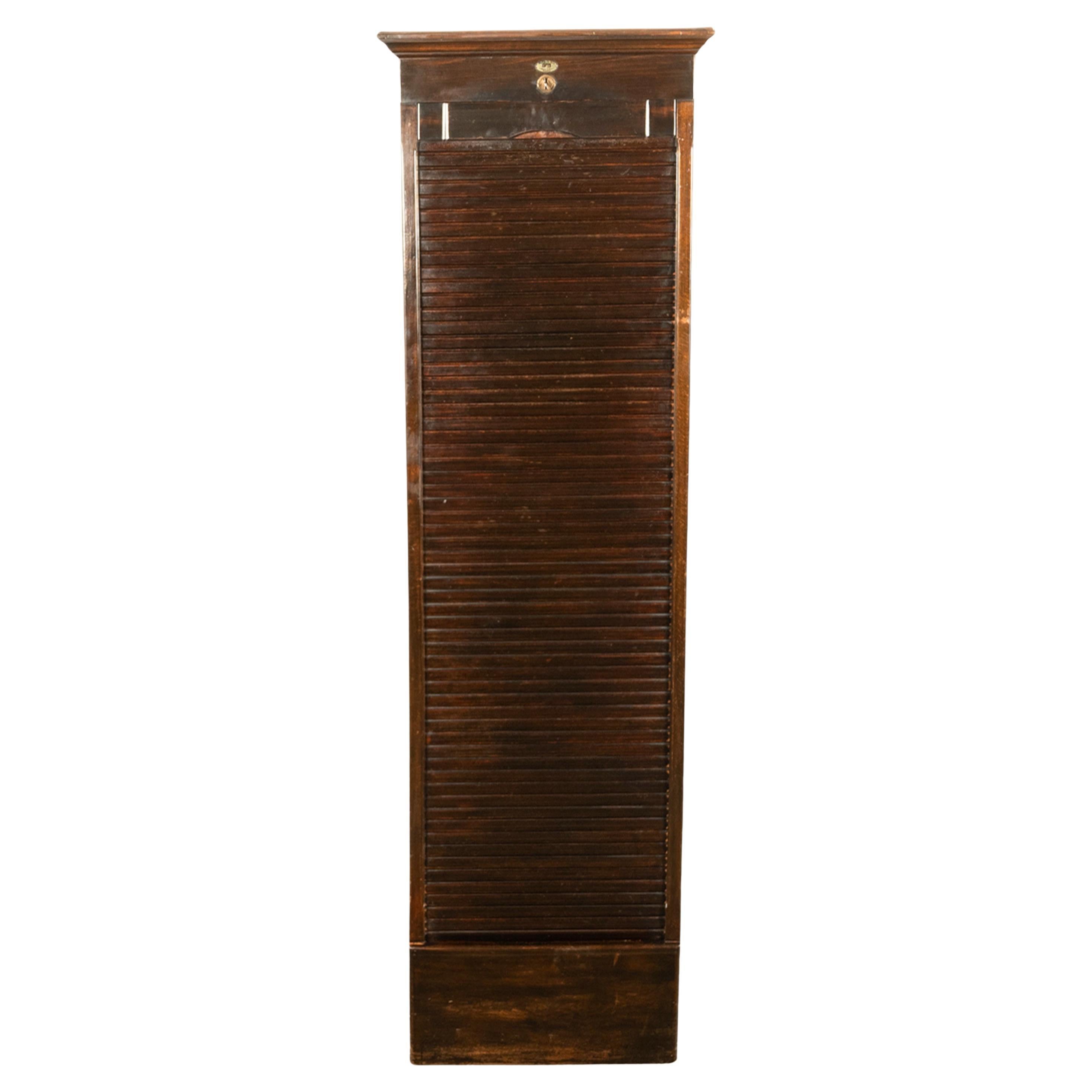 An unusual antique tall tambour fronted roll down walnut filing cabinet made by 