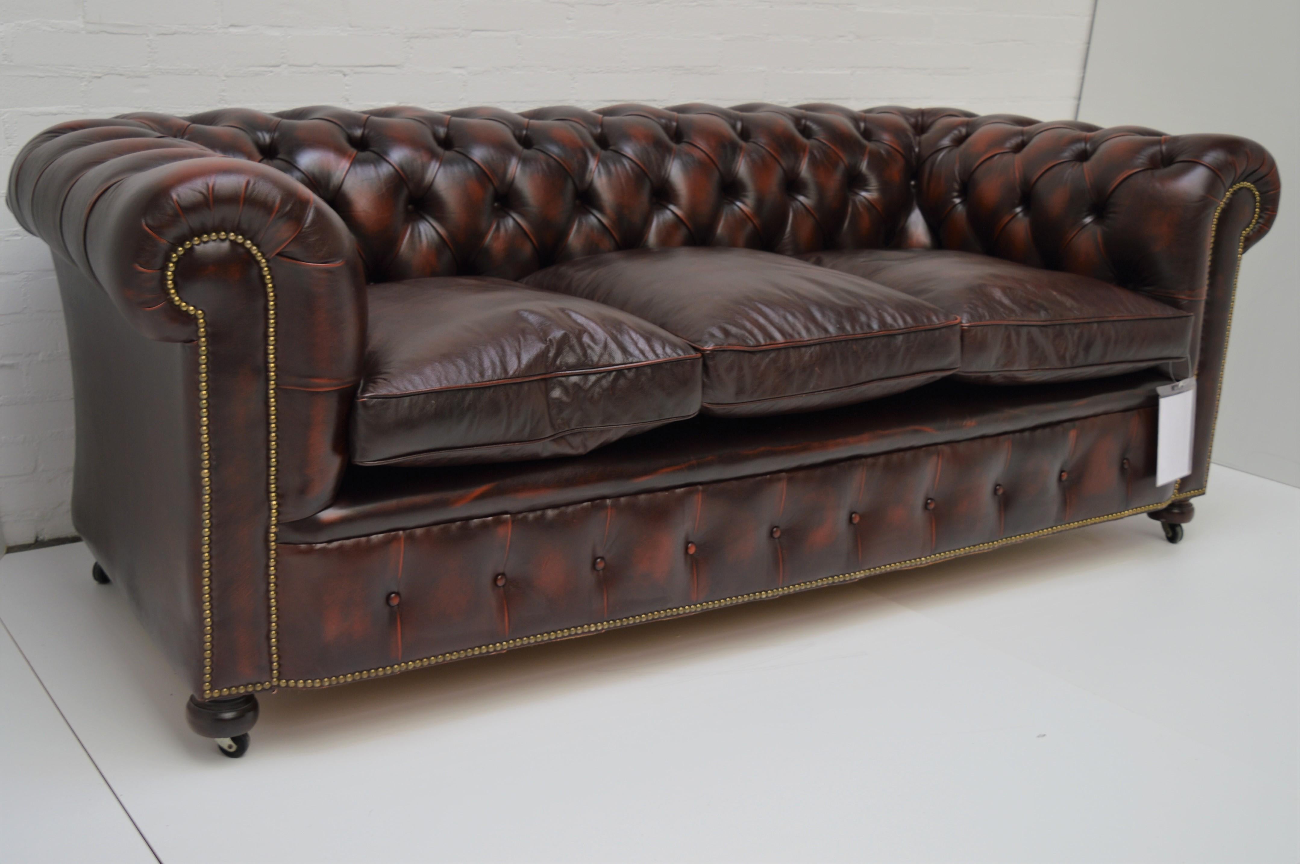 English Antique Tan Chesterfield Sofa with Brass Castors / Wheels For Sale