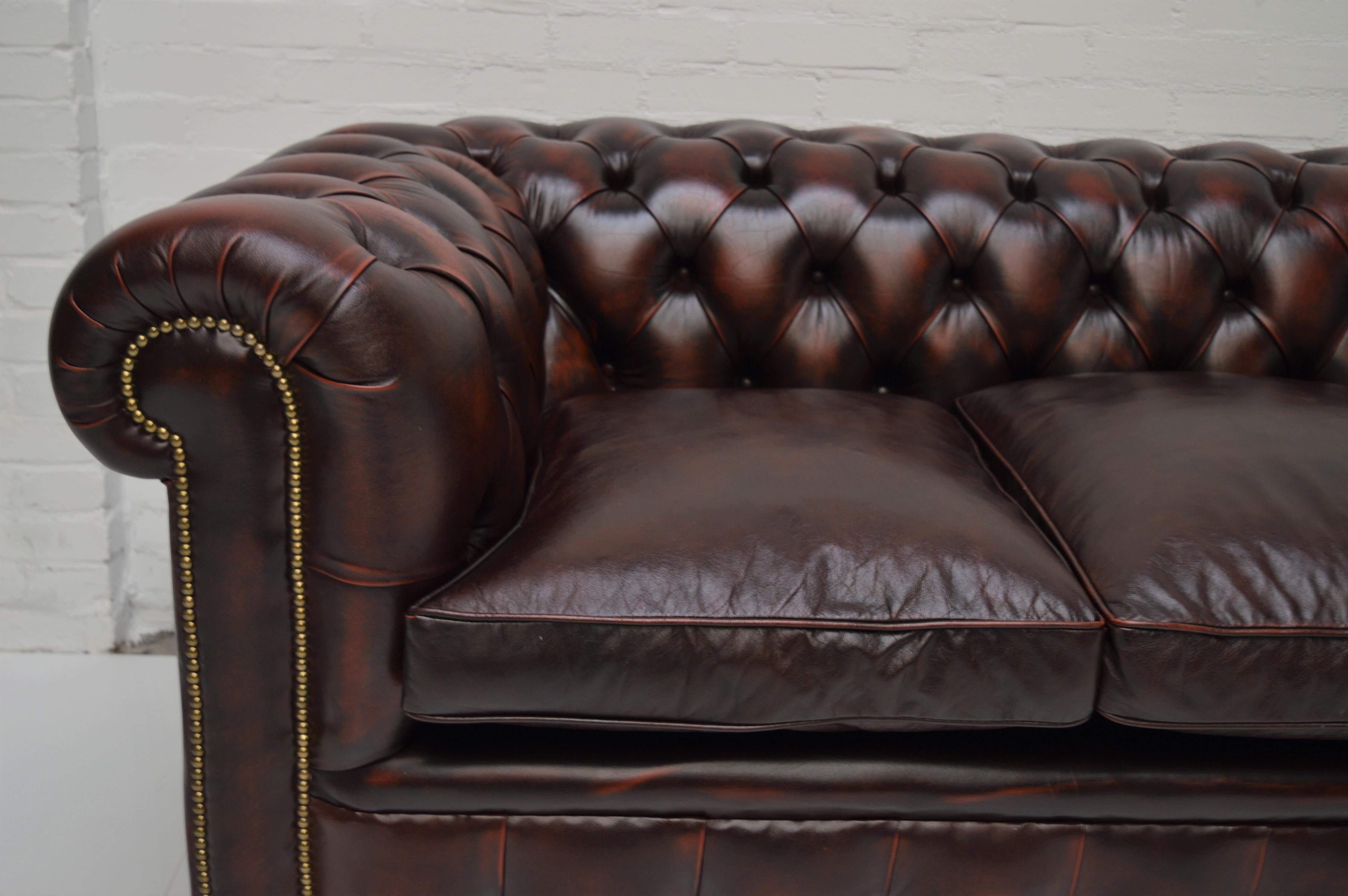 Leather Antique Tan Chesterfield Sofa with Brass Castors / Wheels For Sale