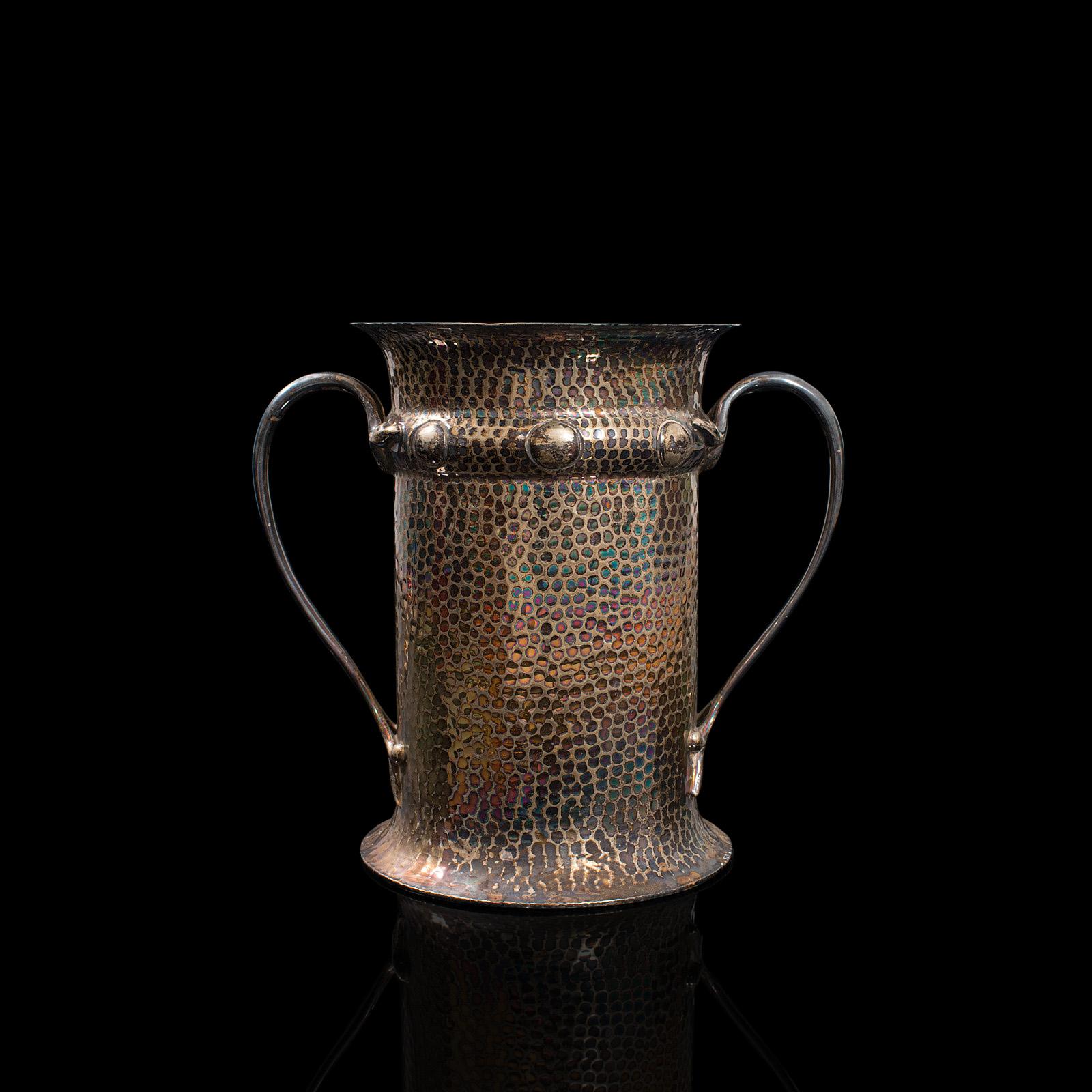 This is an antique twin handled tankard. An English, silver plated jug or display vase with Art Nouveau taste, dating to the late Victorian period, circa 1900.

Ornate decoration presents a distinguished look
Displaying a desirable aged patina