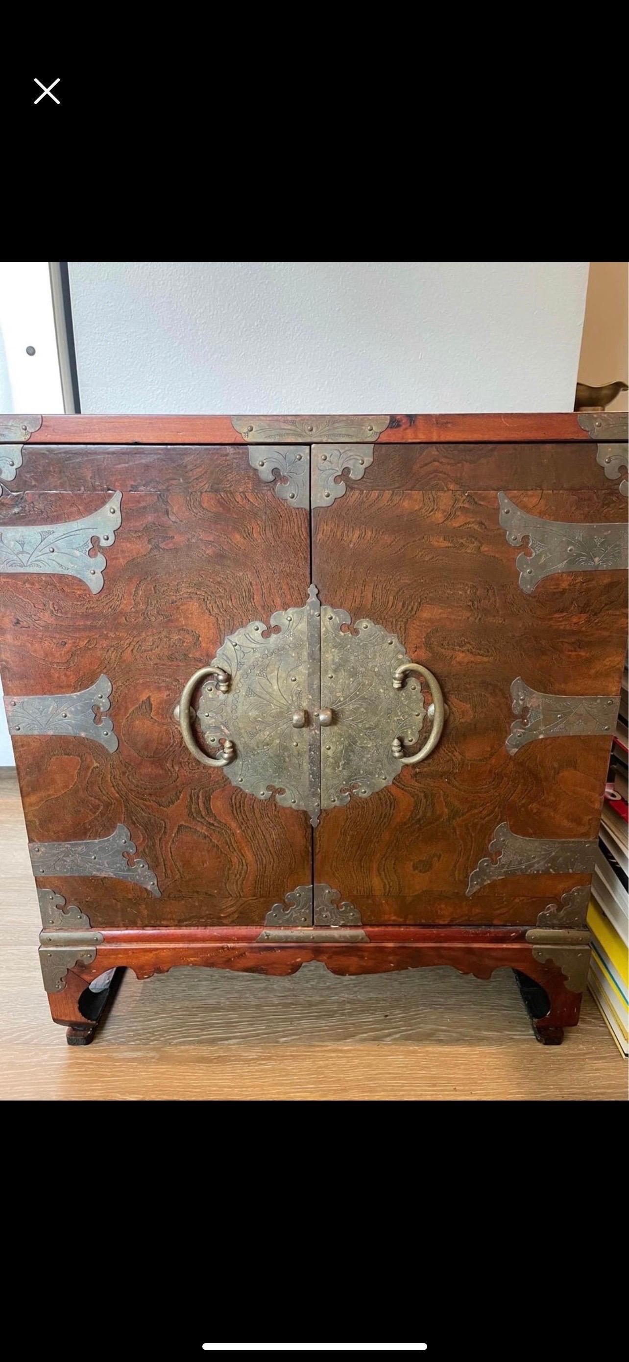 Amazing old cabinet. Beautiful burl wood, metal fixture, even a fish design lock. Looks to be Japanese characters on the back.
Measures: 22” wide
25” tall
12” deep.