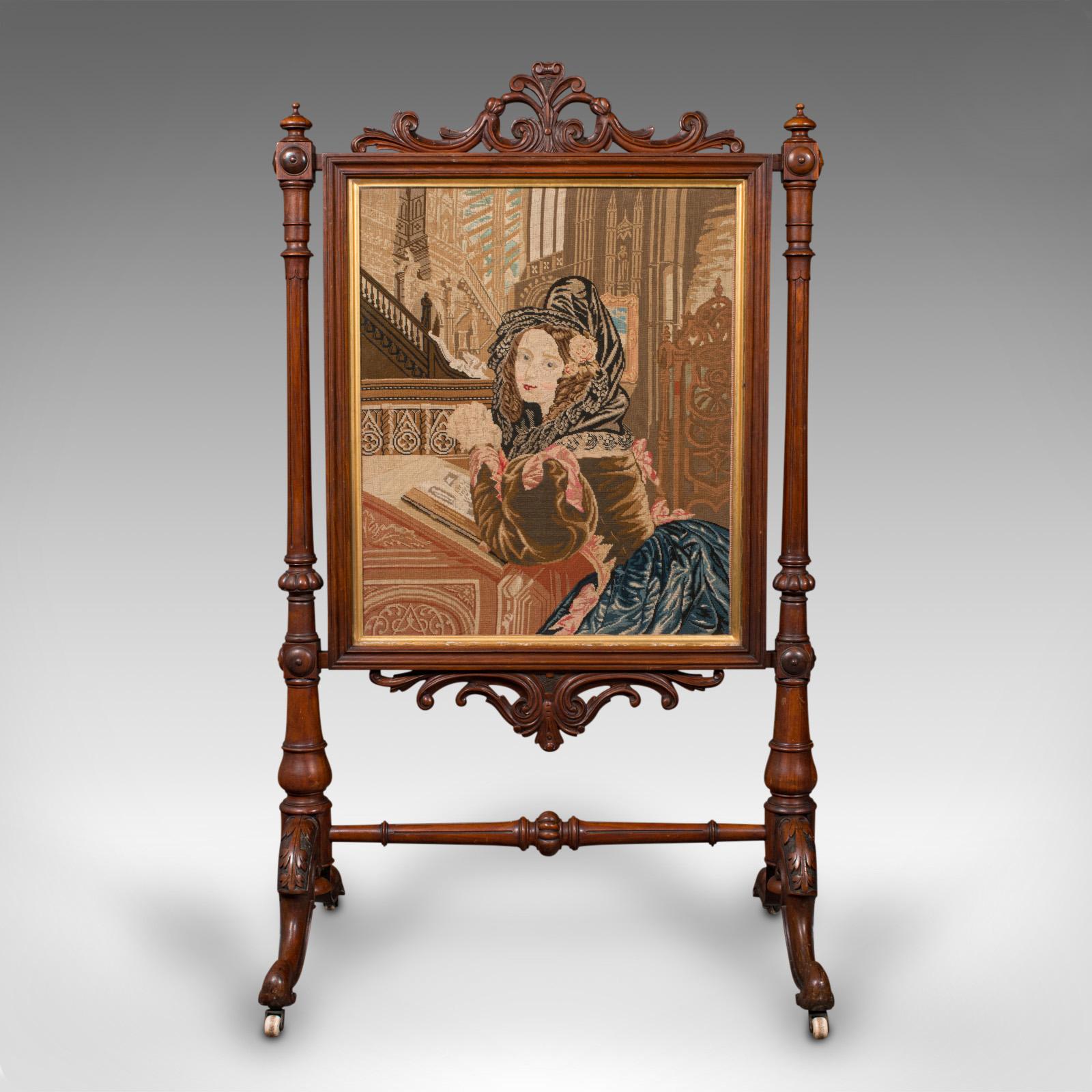 This is an antique tapestry fire screen. An English, walnut and needlepoint fireside panel, dating to the early Victorian period, circa 1840.
 
Exceptional frame quality with a striking embroidered portrait
Displays a desirable aged patina and in