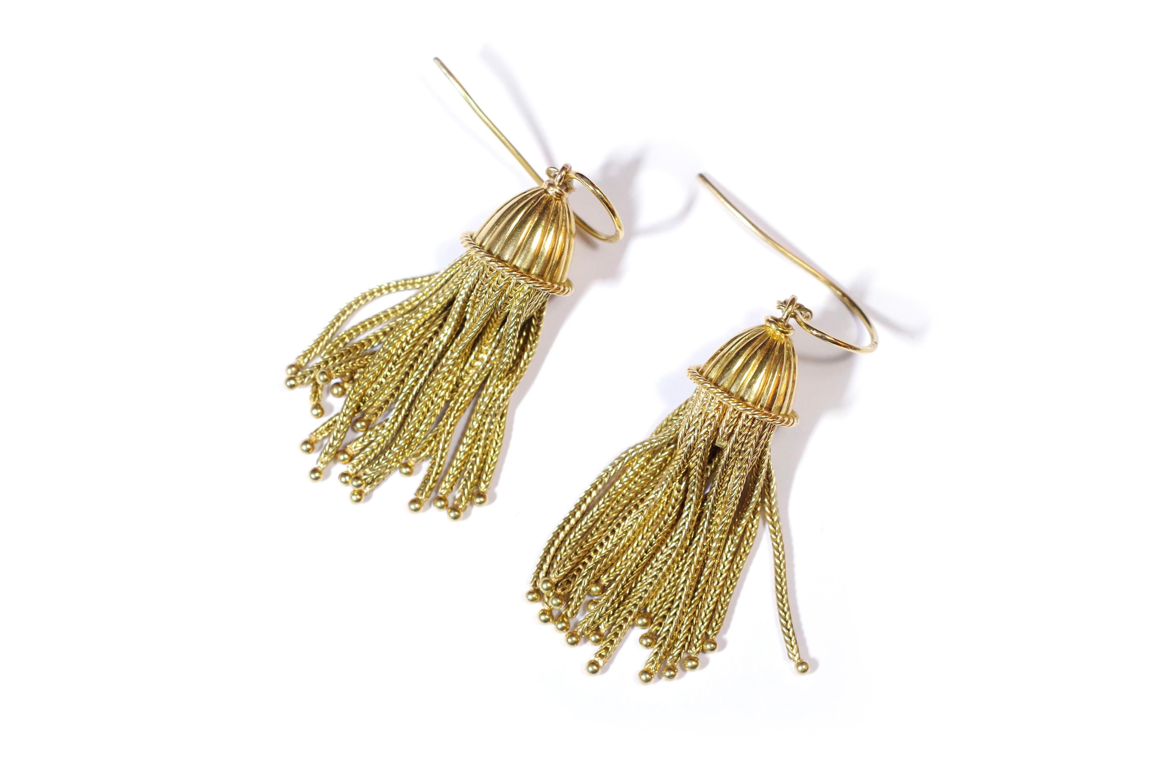 Antique tassels earrings in yellow gold 18 karats. Earrings composed of a chiselled dome with a beaded frieze, gathering a multitude of braided gold strands. The earrings are mounted on a swan neck. Antique tassel earrings, Napoleon III