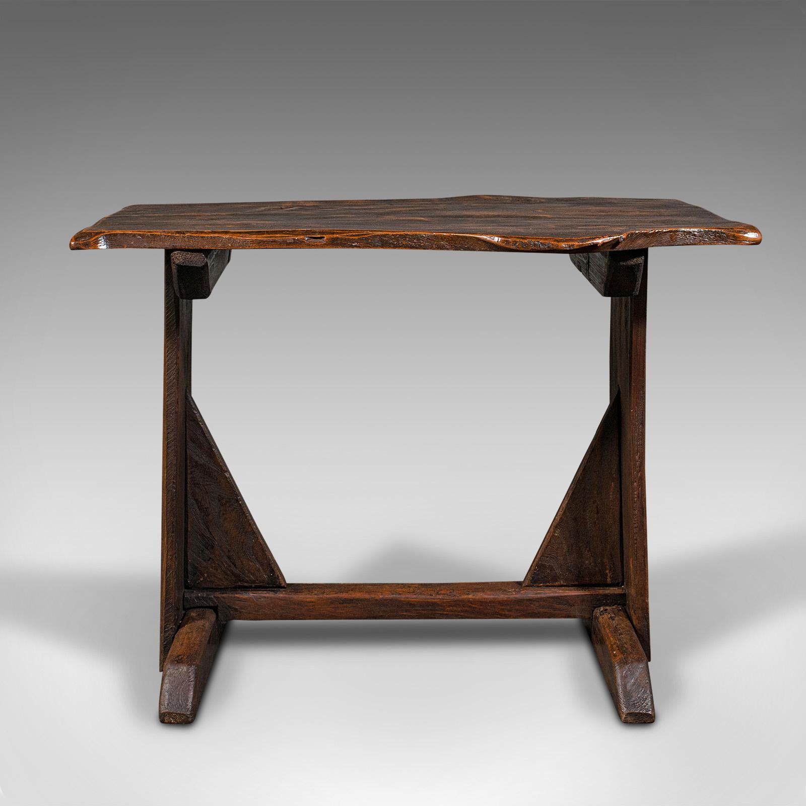This is an antique tavern table. An English, oak occasional or side table with live waney edge, dating to the Georgian period, circa 1800.

Captivating antique table, with copious character
Displays a desirable aged patina and weathering
Select