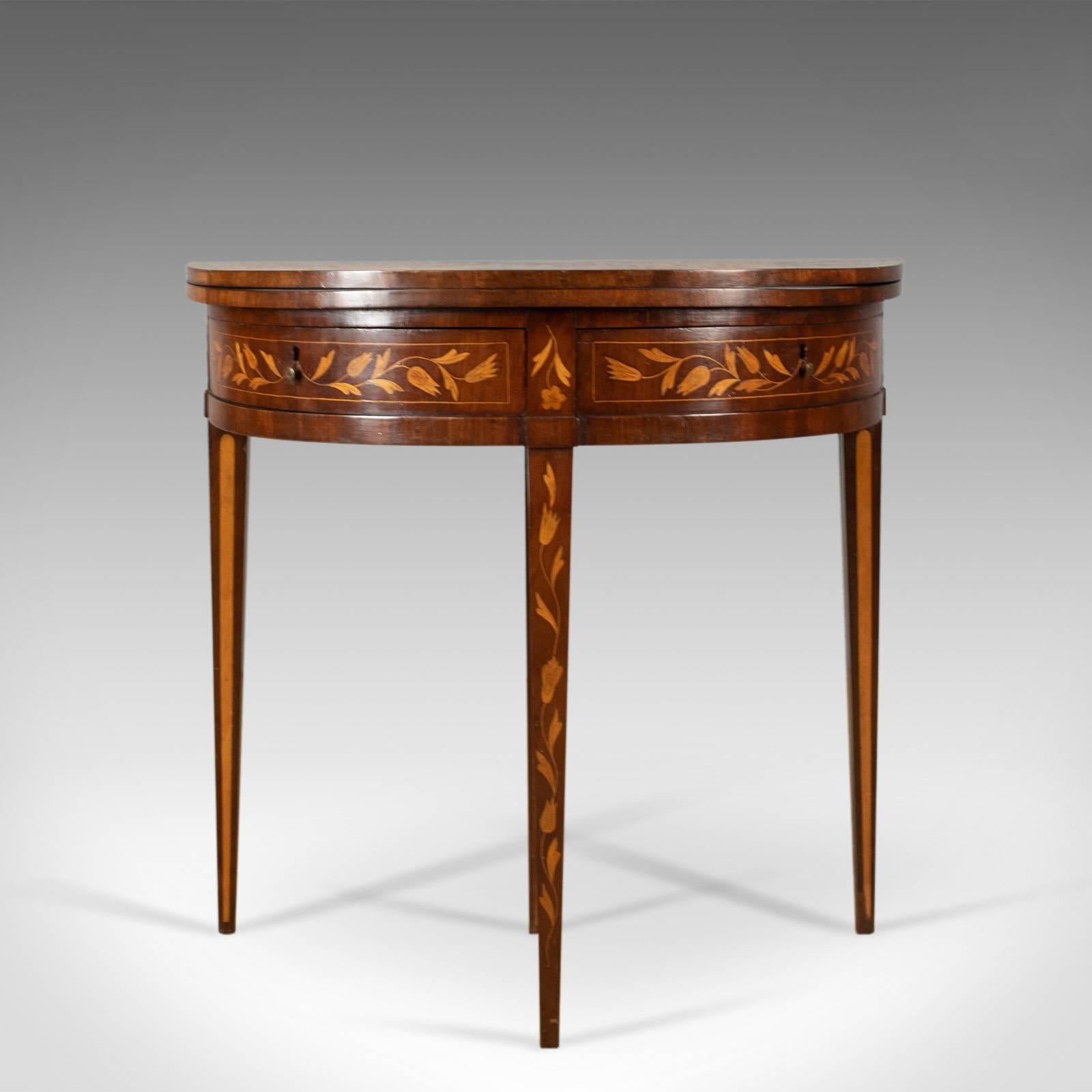 This is an antique tea table, a Dutch, fold over, inlaid, mahogany side table dating to circa 1780.

Mahogany with grain interest and good colour throughout
Desirable aged patina with a wax polished finish
Extensively decorated with well