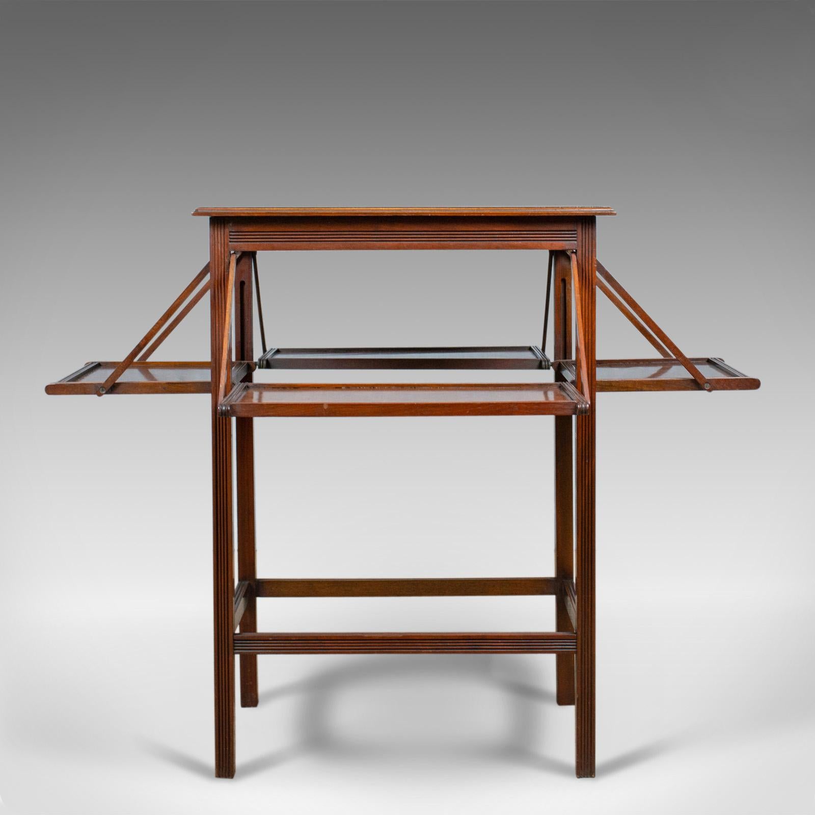 This is an antique tea table. An English, Edwardian, walnut cake stand with four folding leaves dating to the early 20th century, circa 1910.

Warm hues to the English walnut
Good consistent color with grain interest throughout
Wax polished
