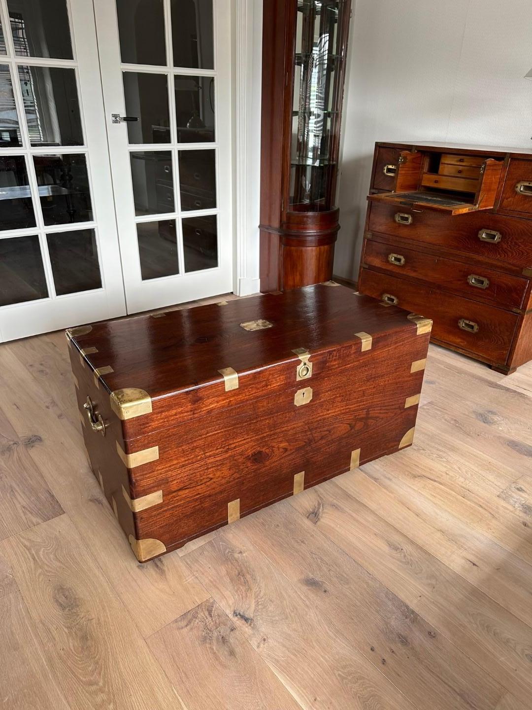 In the world of antique furniture, few pieces possess the timeless allure and historical significance of the colonial teak chest with brass corners and carrying handles. This magnificent chest is more than just a piece of wood and metal; it's a
