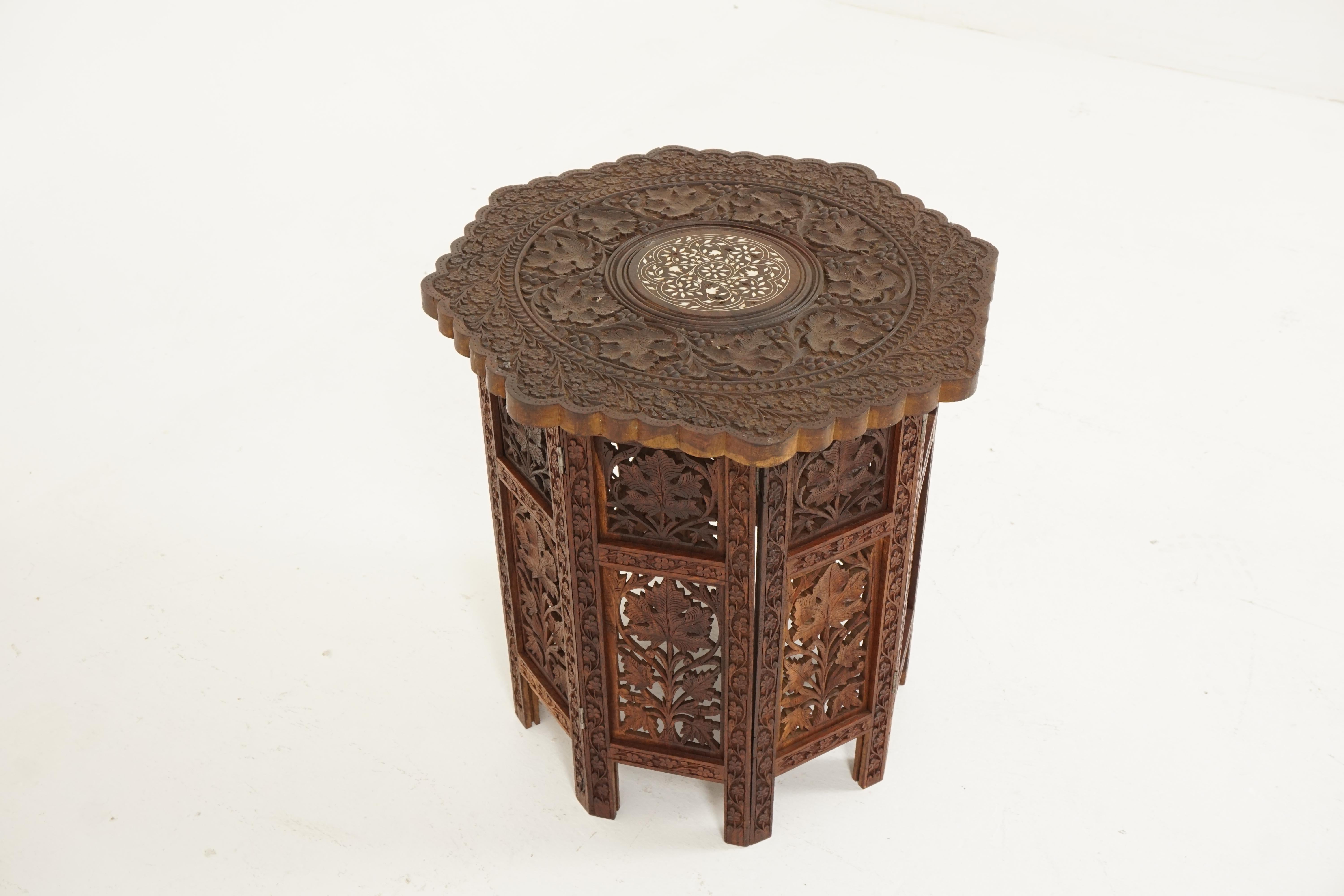 Antique teak table, carved Campaign table, inlaid table, India, 1920s

India 1920s
Solid teak
Original finish
Octagonal top with bone inlay
Pierce carved fretwork with foliate detail
Dismantles into folding legs
Solid teak construction
Nice