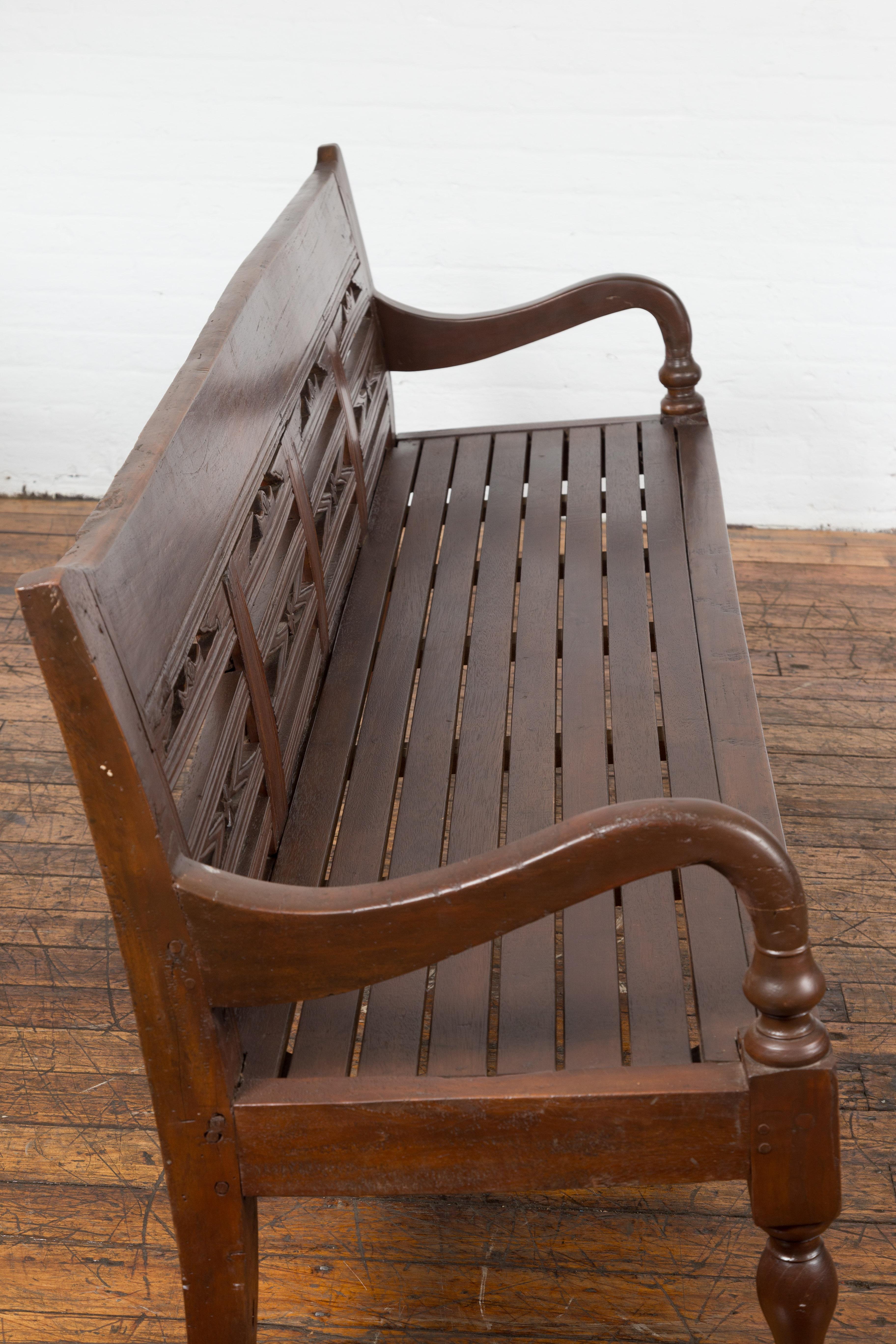 Antique Teak Wood Javanese Settee with Hand-Carved Back and Scrolling Arms For Sale 8