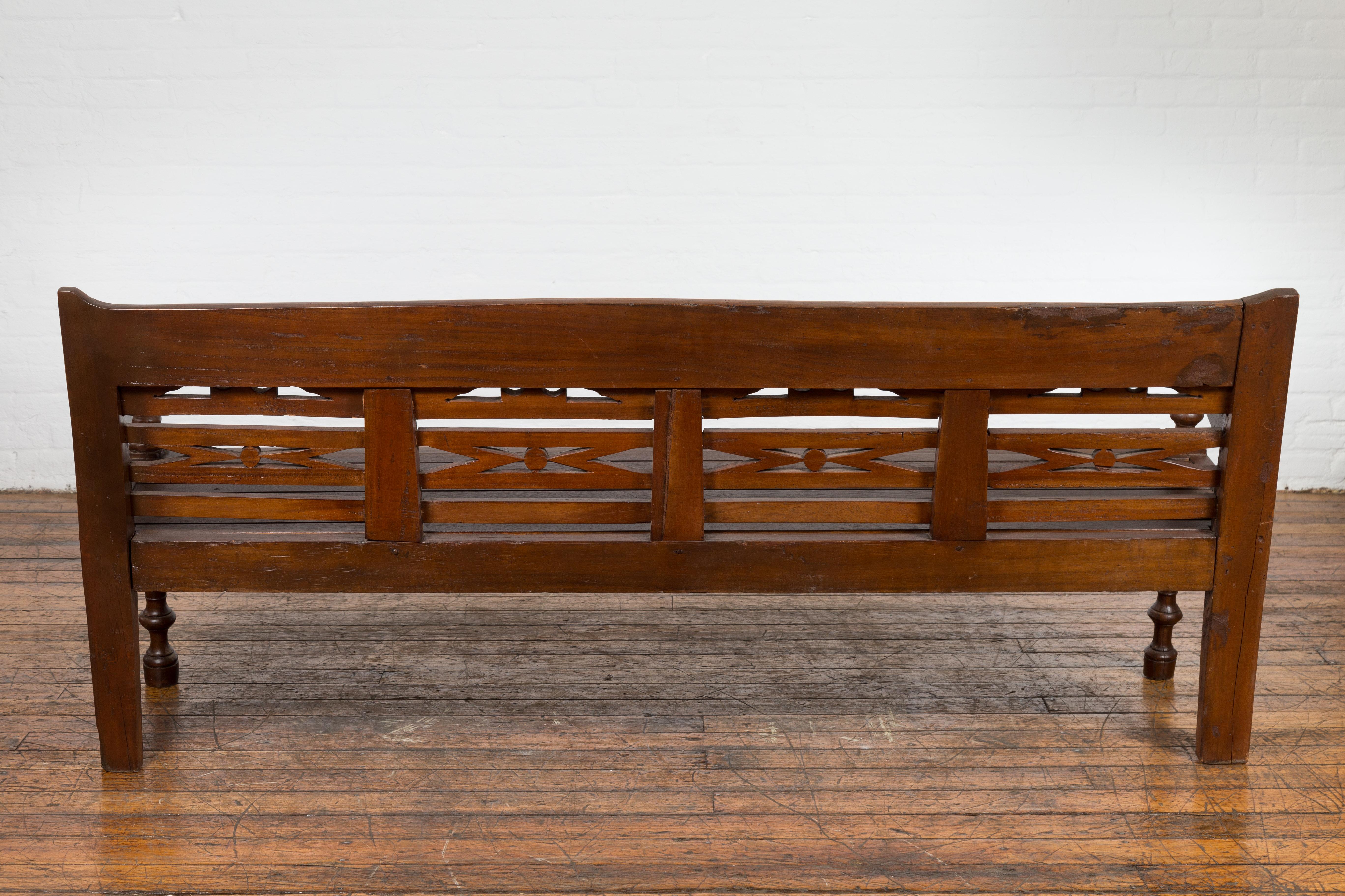 Antique Teak Wood Javanese Settee with Hand-Carved Back and Scrolling Arms For Sale 9