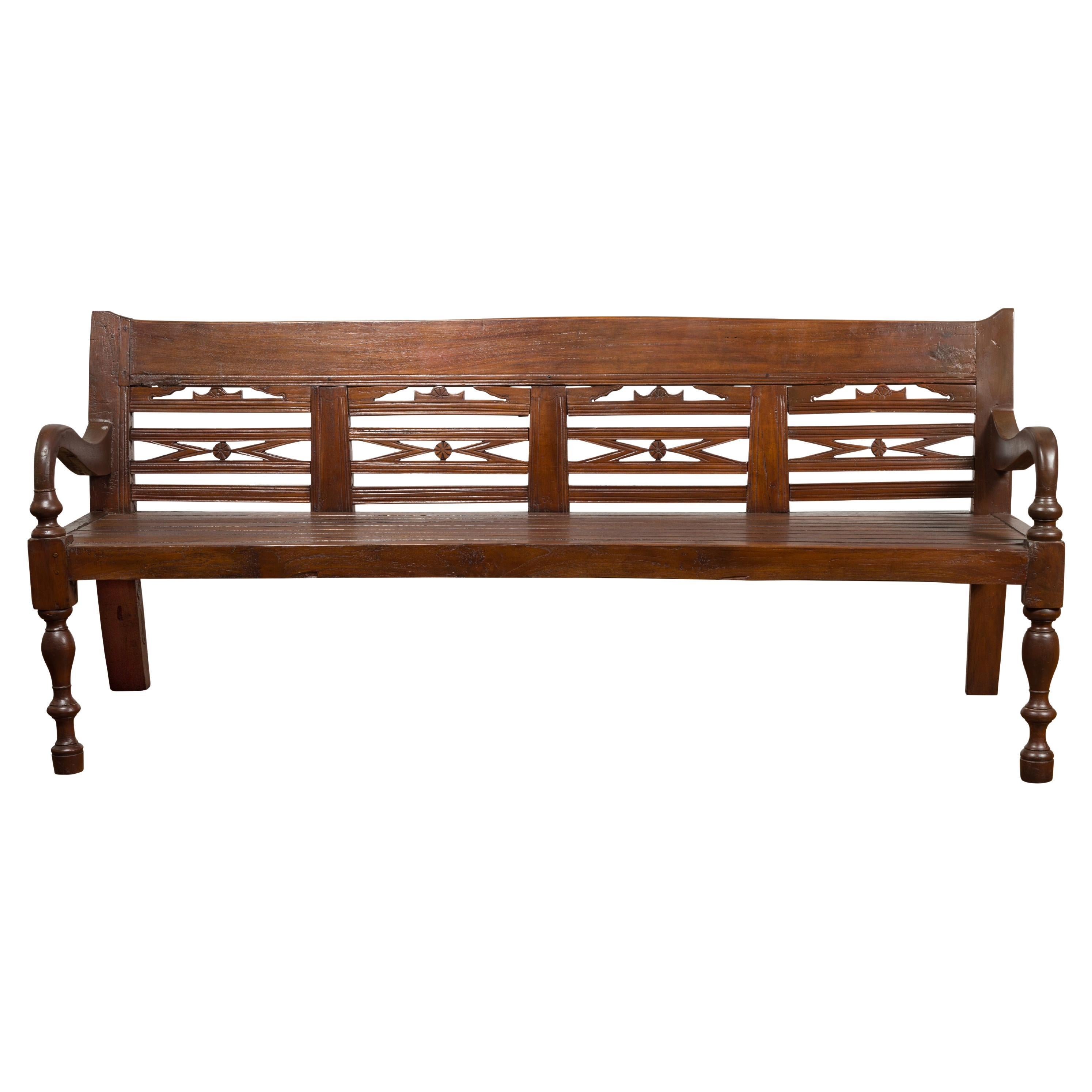 Antique Teak Wood Javanese Settee with Hand-Carved Back and Scrolling Arms For Sale