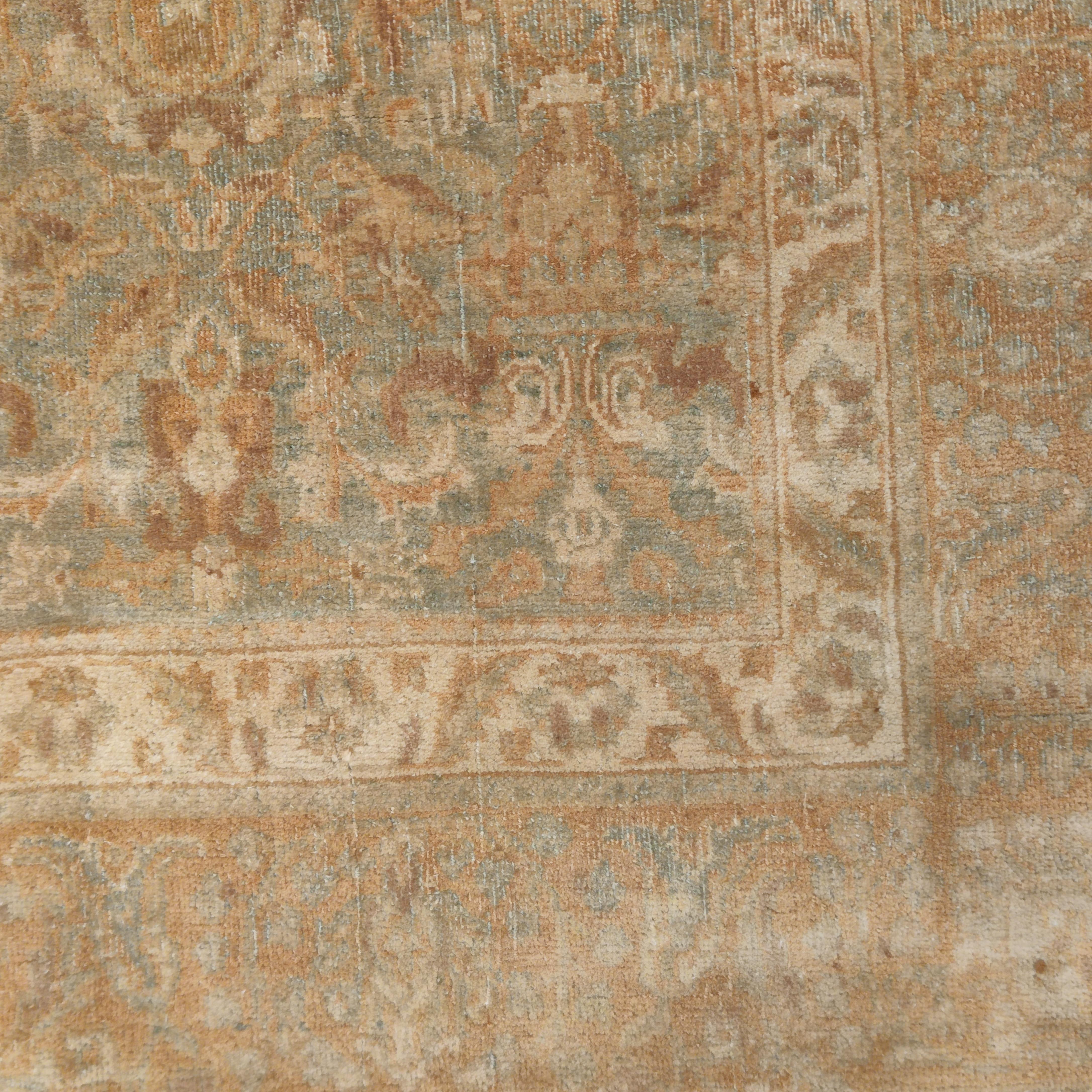 A finely knotted antique Agra rug distinguished by a soft, teal blue background embellished by various gradations of colour, and decorated by an infinite repeat 'herati' pattern. The restrained palette used in this rare small Agra gives it a