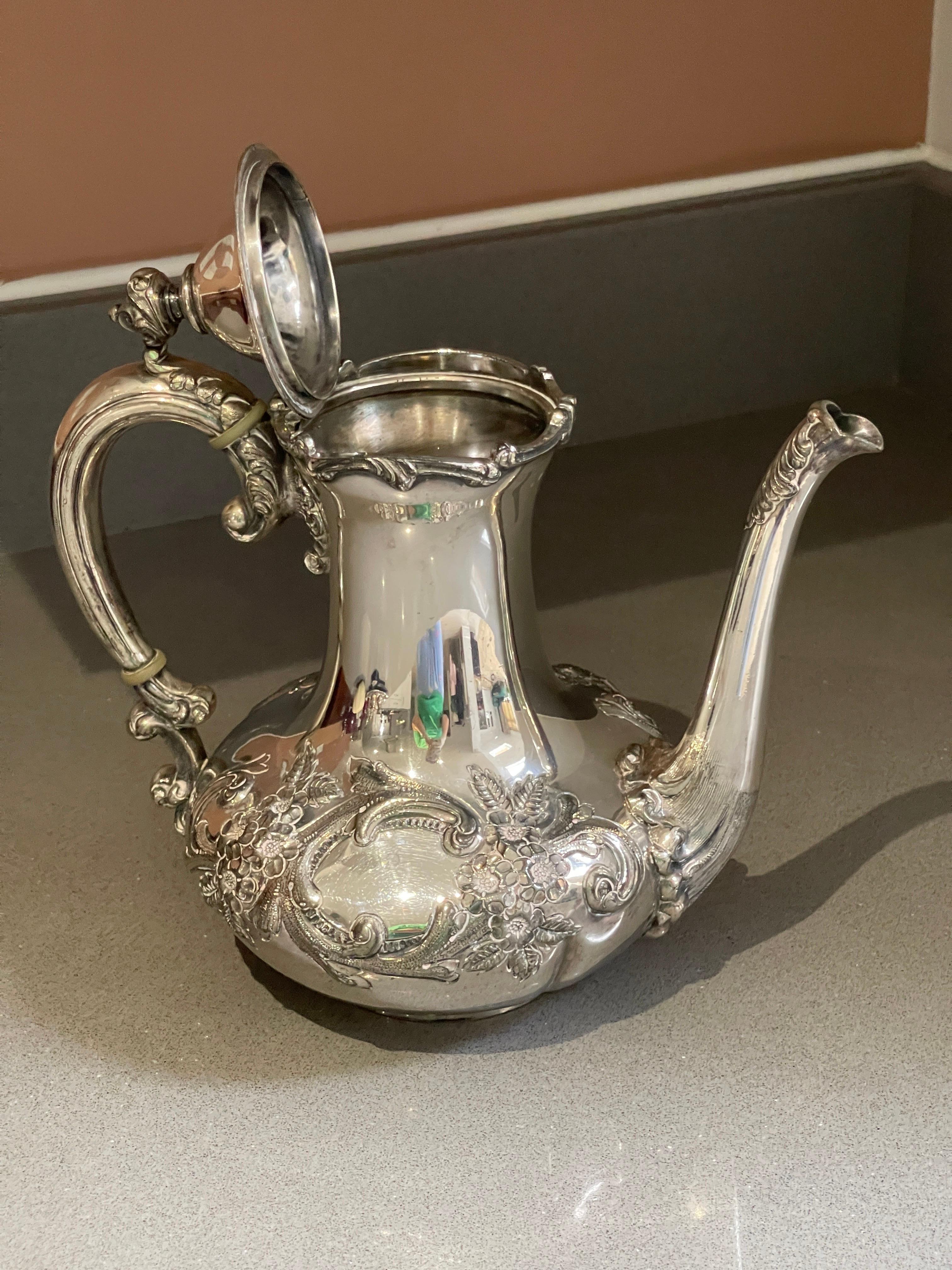 An antique tea set and a silver-plated teapot that is beautifully designed and created are suitable for elegant serving. With lid pressed, cast and chased, gold gilding on the inside. Oval, domed body on short, curved feet with hinged, vaulted lid.