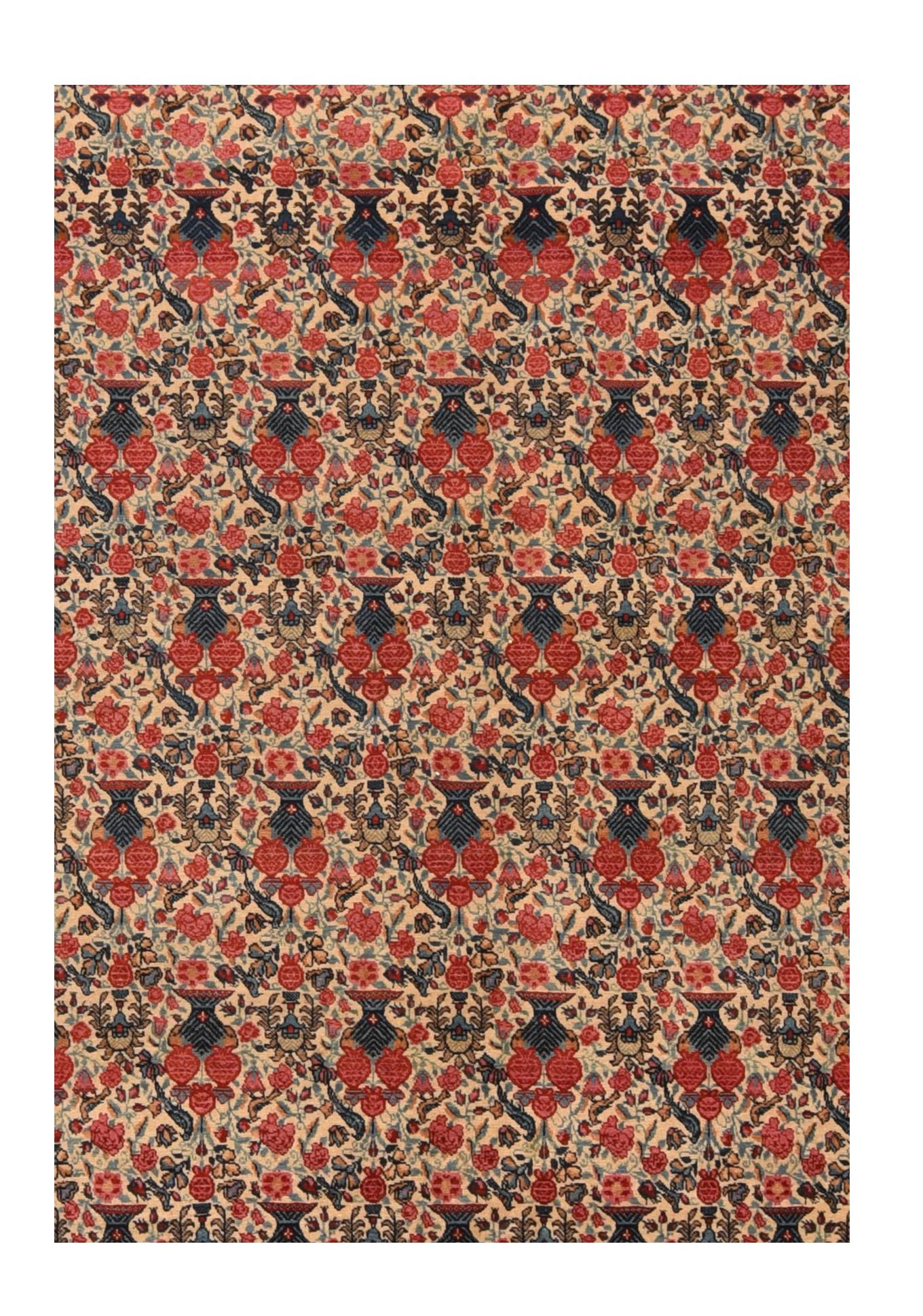 The allover Zil-i-Sultan (“shadow of the sultan” design was particularly popular in Persia in the later 19th century. This interpretation features offset rows of navy vases with red roses, on a cream-straw ground, with a dense infill of palmettes