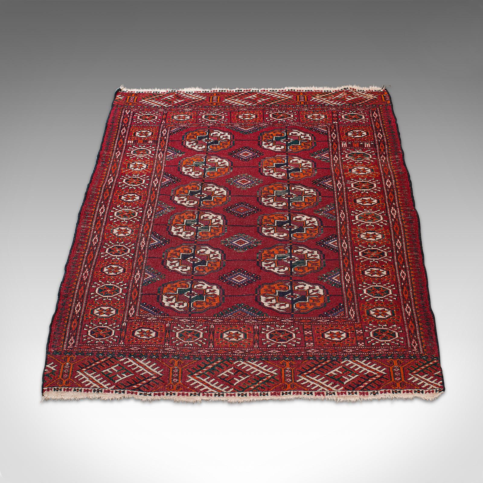 This is an antique Tekke Bokhara rug. A Middle Eastern, nomadic Turkoman carpet or wall covering, dating to the late 19th century, circa 1900.

Add warmth to your room with this deep red rug
Displaying a desirable aged patina - presenting minimal